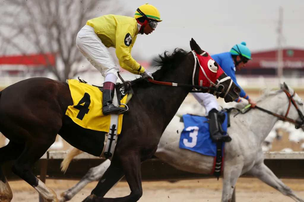 Jockey Kevin Roman and horse Just Luck try to pass Larren Delorne at Fonner Park in Grand Island on Saturday, March 2, 2024. Roman and Just Luck finished in fourth place. The live racing season at Fonner continues through Kentucky Derby day on May 4.<br />(Gracie Smith / Flatwater Free Press)