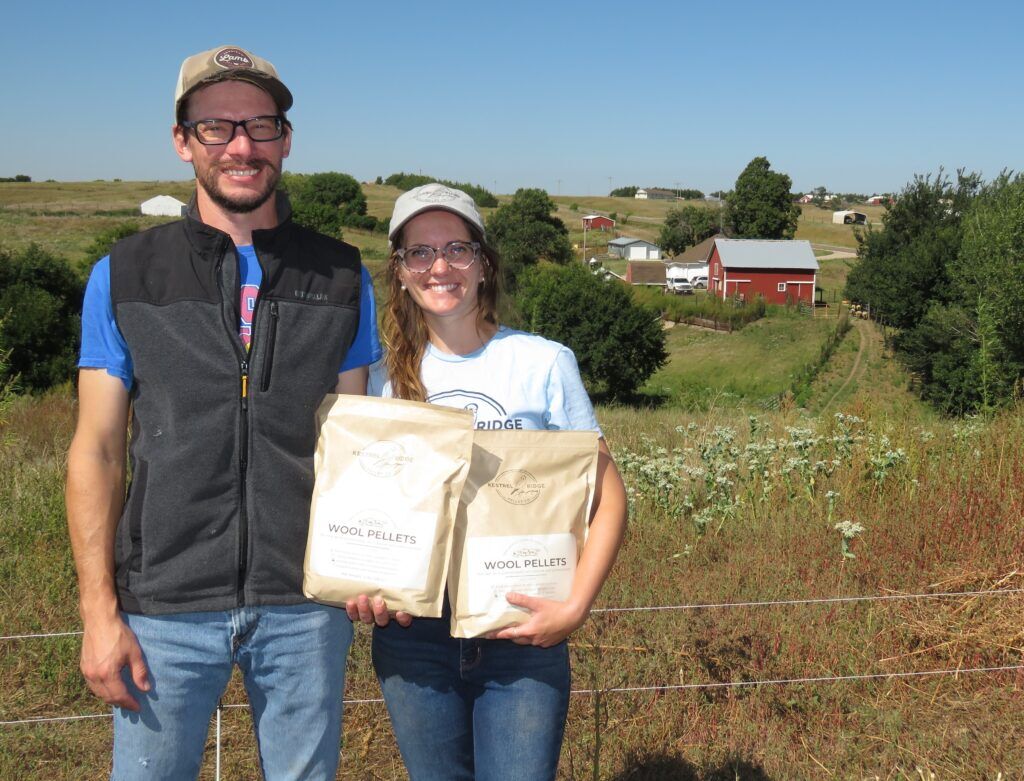Megan Landes-Murphy and her husband Tom Murphy fulfilled a dream in 2021 when they bought some sheep and 12 acres of mostly pasture land along Highway 4 near Lawrence. Their 100-year-old house, barn and other outbuildings stand in the background.<br />(Lori Potter / Flatwater Free Press)