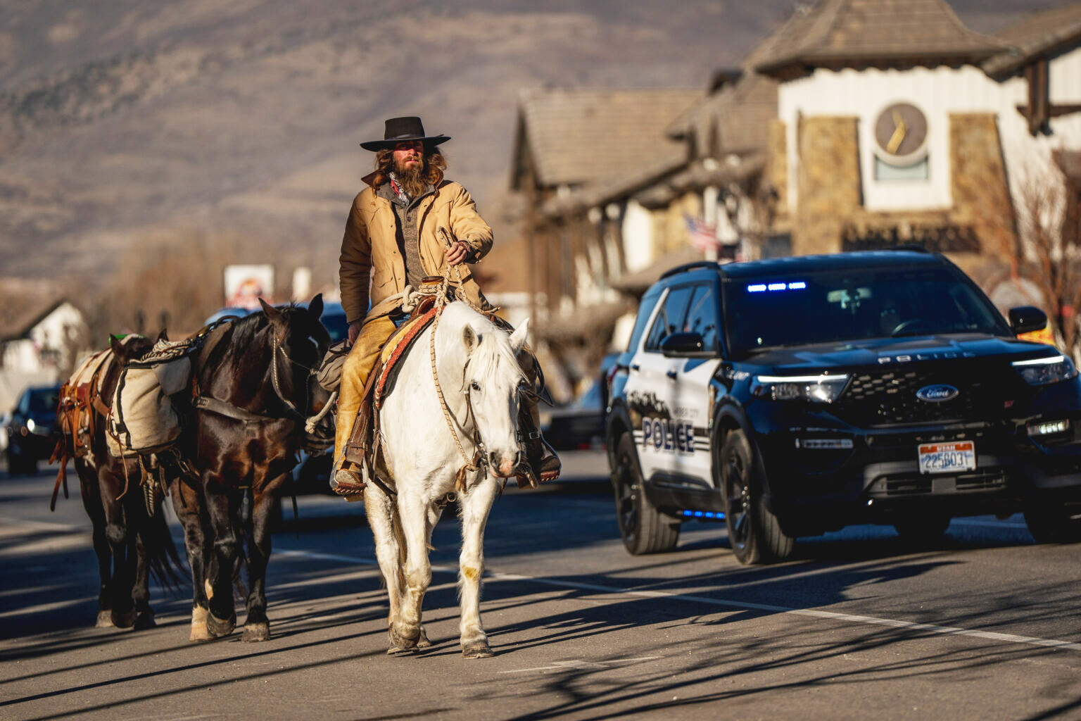 Police provide an escort as Jake Harvath rides through Heber City on Thursday, Dec. 5, 2024.<br />(Spenser Heaps / Utah News Dispatch)
