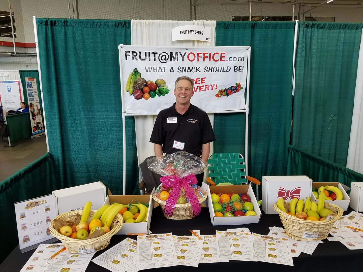 Sheldon Hawkins poses for a photo at his <a href="mailto:Fruit@MyOffice">Fruit@MyOffice</a> booth at a trade fair apporximately 5 years ago. <a href="mailto:Fruit@MyOffice">Fruit@MyOffice</a> offers a basket program that provides fruit and snacks to your employees. A professional from <a href="mailto:Fruit@MyOffice">Fruit@MyOffice</a> will deliver your fruit anywhere in the Omaha Metropolitan area on a weekly, biweekly or monthly basis. (Courtesy of <a href="mailto:Fruit@MyOffice">Fruit@MyOffice</a>)