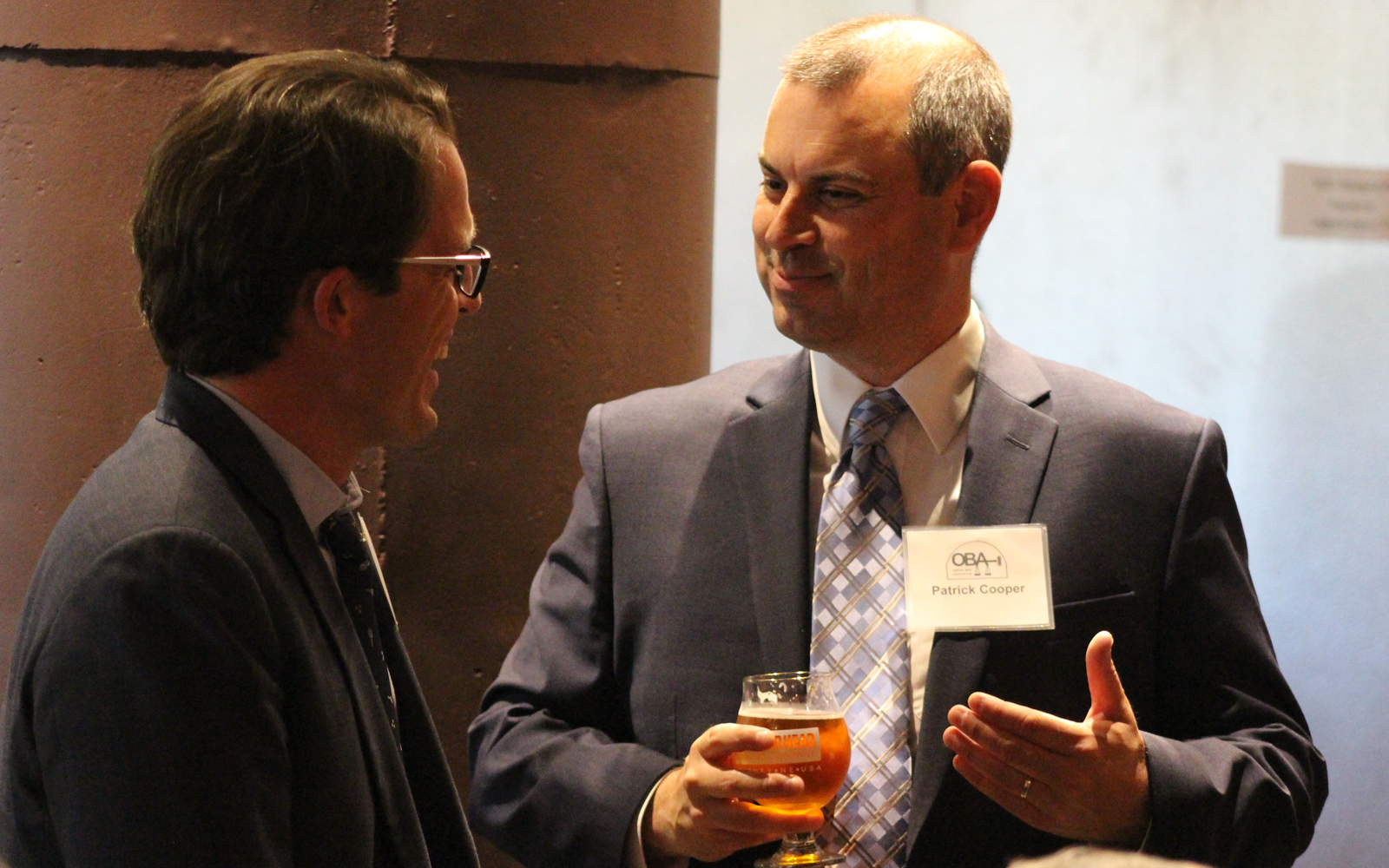Omaha Bar Association President Patrick Cooper, right, speaks with OBA Executive Director Dave Sommers at the OBA President’s Reception on June 4, 2019, at Thunderhead Brewing, 1037 Jones St. (Photo by Scott Stewart)