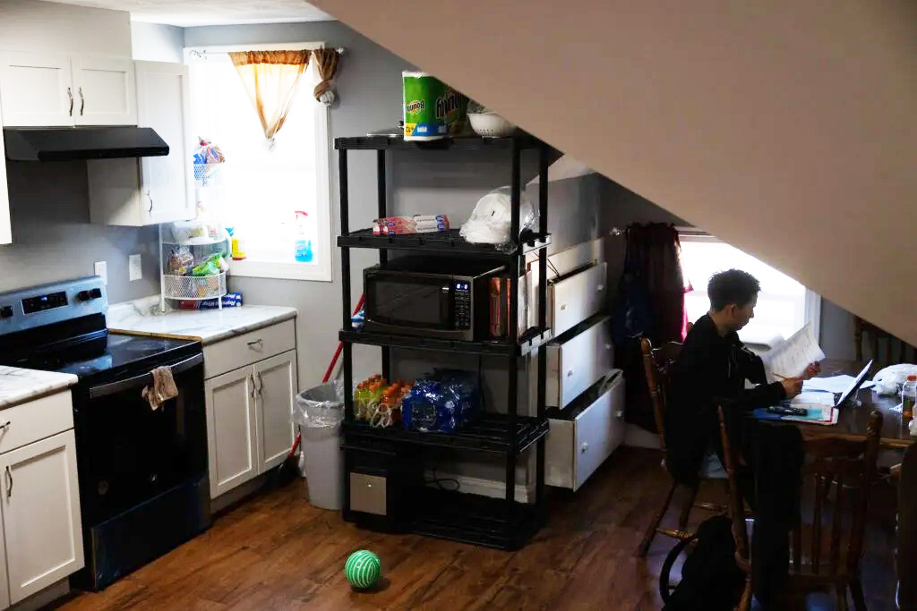 Following an overnight shift and a morning of classes, Marco Gutiérrez works on homework at the kitchen table in the apartment he shares with his sister’s family. When he arrived in the U.S., he spent two weeks in a shelter for unaccompanied minors before the government let him join his older sister in Schuyler.<br />(Rebecca S. Gratz / Flatwater Free Press)