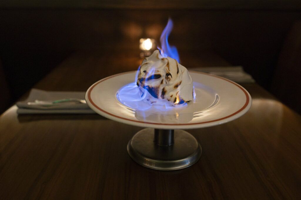 Baked Alaska, a rare dessert in Omaha restaurants, gets flambéed to order at the diners’ tableside before being served.<br />(Ryan Soderlin / Flatwater Free Press)