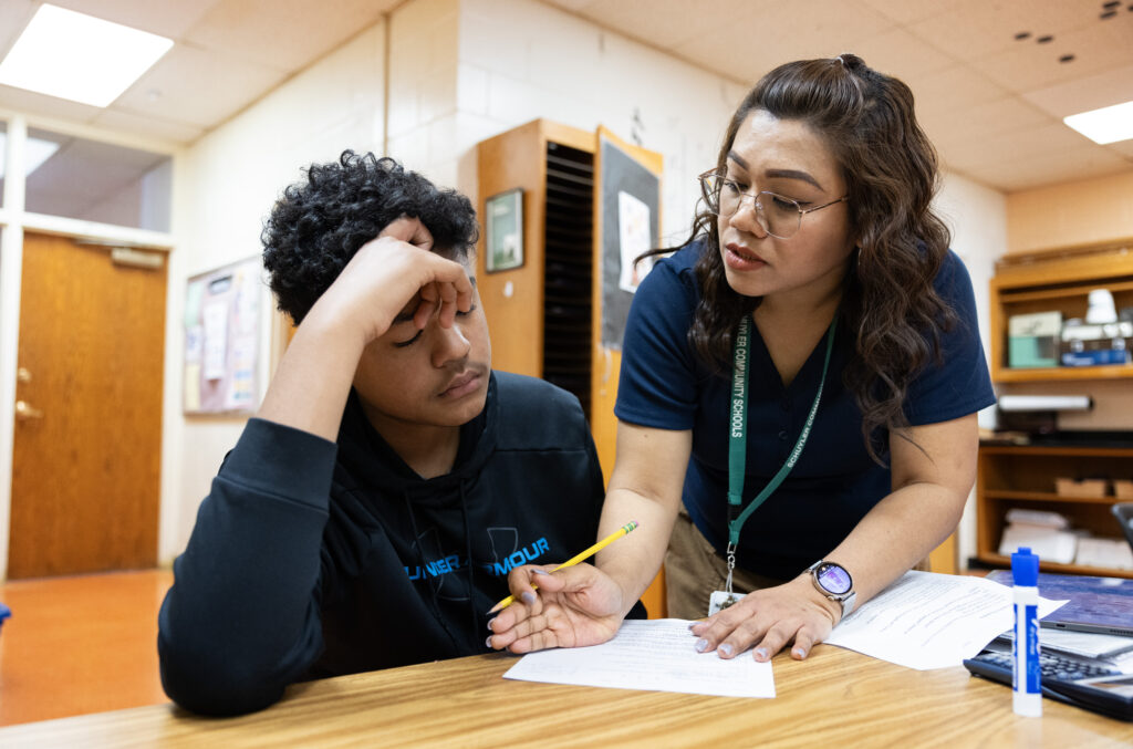 Ramos (right) helps freshman Cesar Nava, 15, with a worksheet in a physical science class on May 2, 2025.<br />(Rebecca S. Gratz / Flatwater Free Press)