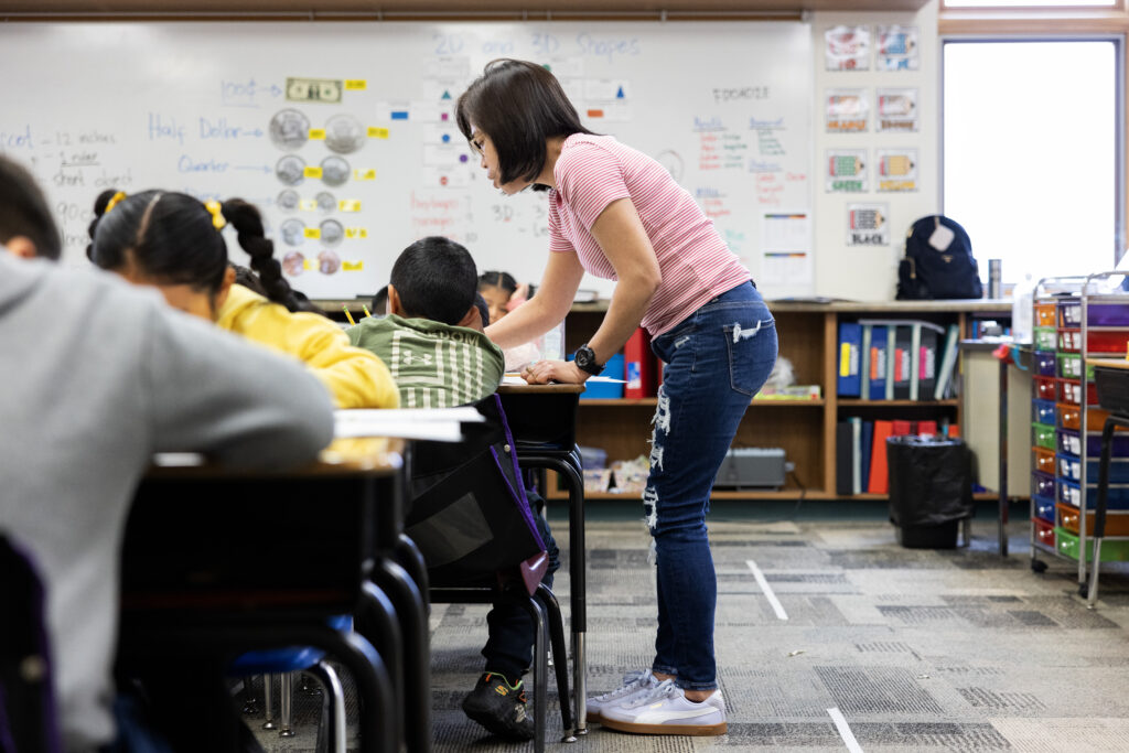 Cariit helps her second grade students at Schuyler Elementary School.<br />(Rebecca S. Gratz / Flatwater Free Press)