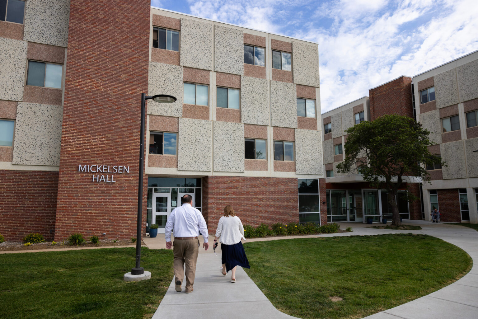 Chris Tonniges (left) CEO of Lutheran Family Services, and Stephanie Gardeman, director of the Root and Rise Program, walk into Mickelsen Hall on the former Dana College campus Friday, Sept. 12, 2025, in Blair, Neb.<br />(Rebecca S. Gratz / Nebraska Examiner)