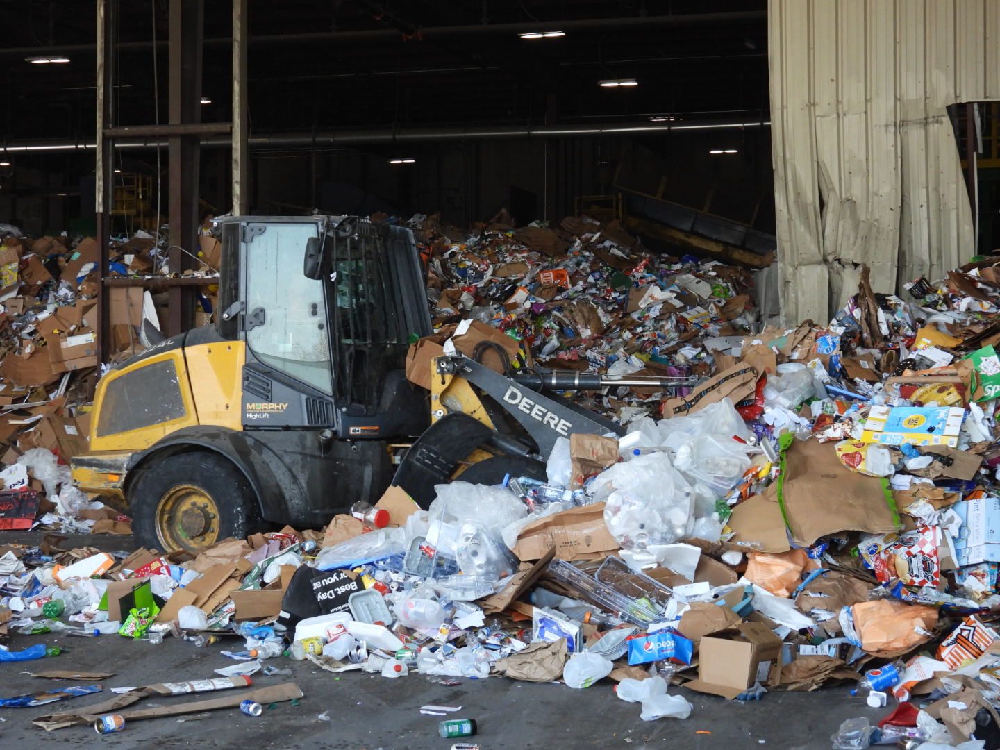 An employee clears an area of recently delivered recycled items to First Star.<br />(Tim Trudell / The Daily Record)