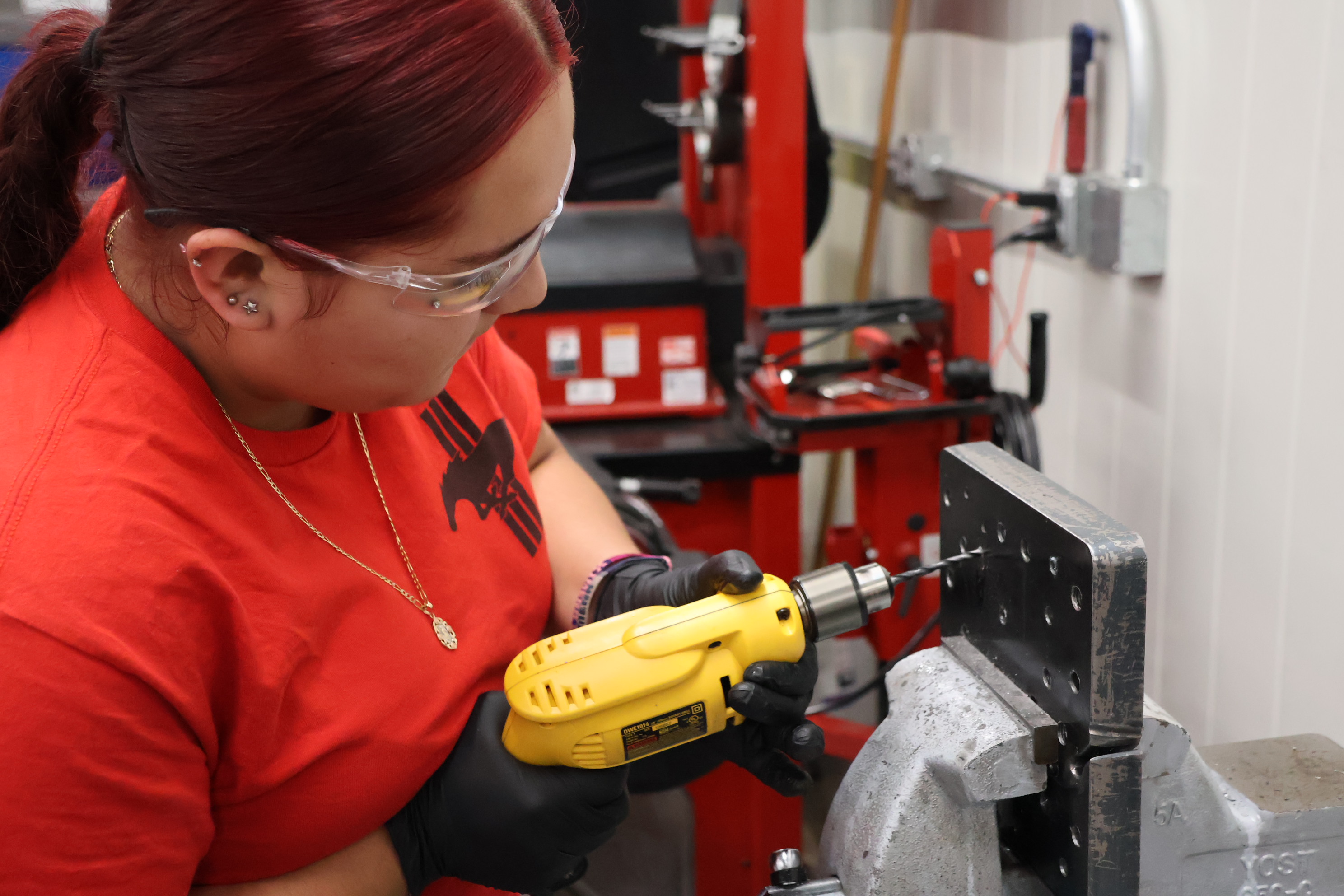 A students practices thread repair in the automotive program’s work area.<br />(Tim Trudell / The Daily Record)