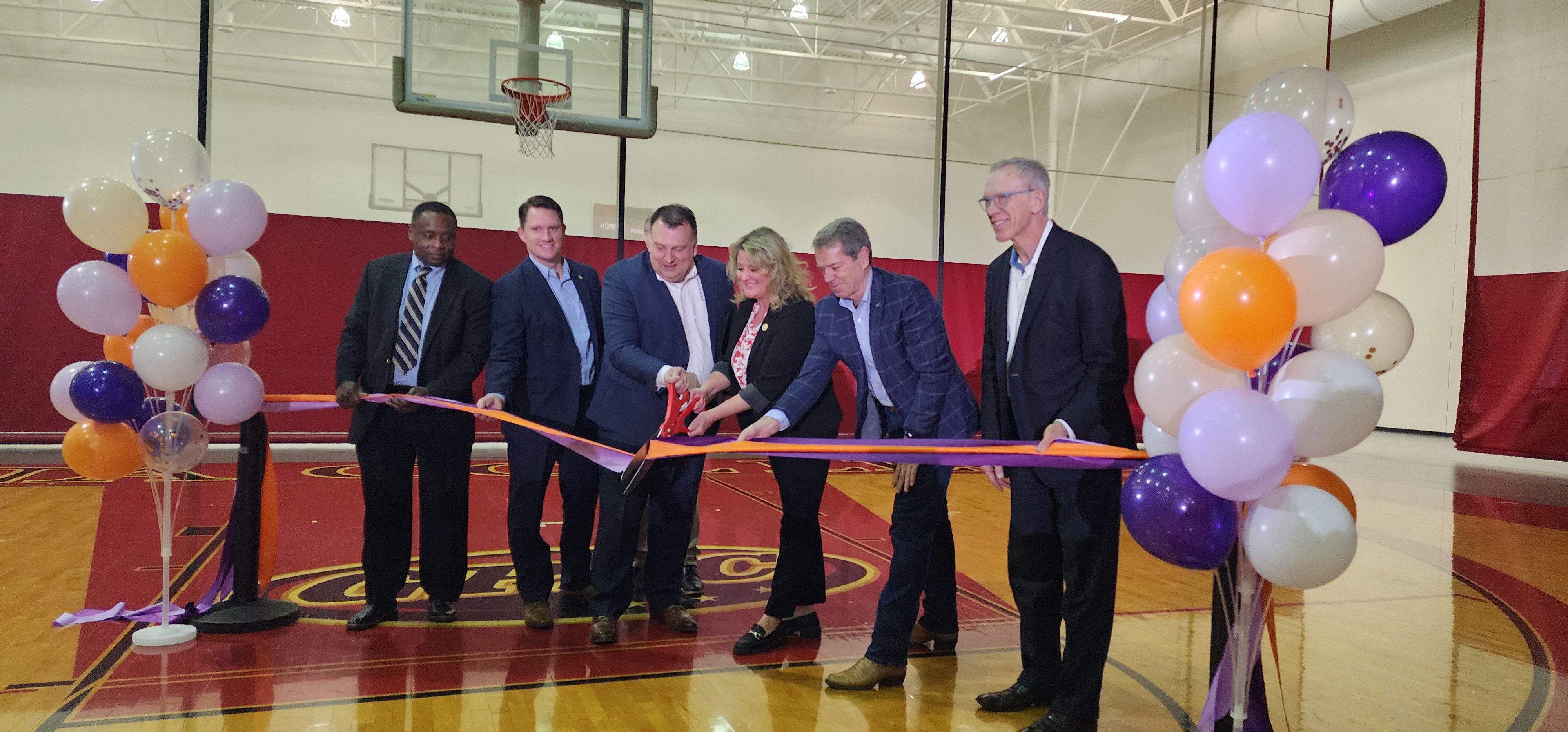 On February 9, Chris Tonniges of Lutheran Family Services and Blair Mayor Mindy Rump completed a symbolic ribbon-cutting ceremony as Nebraska Gov. Jim Pillen and other dignitaries look on.