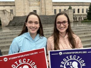 Lincoln twins Bridget and Cecilia Nickman, 17,  supported the Supreme Court reversal of Roe v. Wade at a student rally last year. (Aaron Sanderford / Nebraska Examiner)