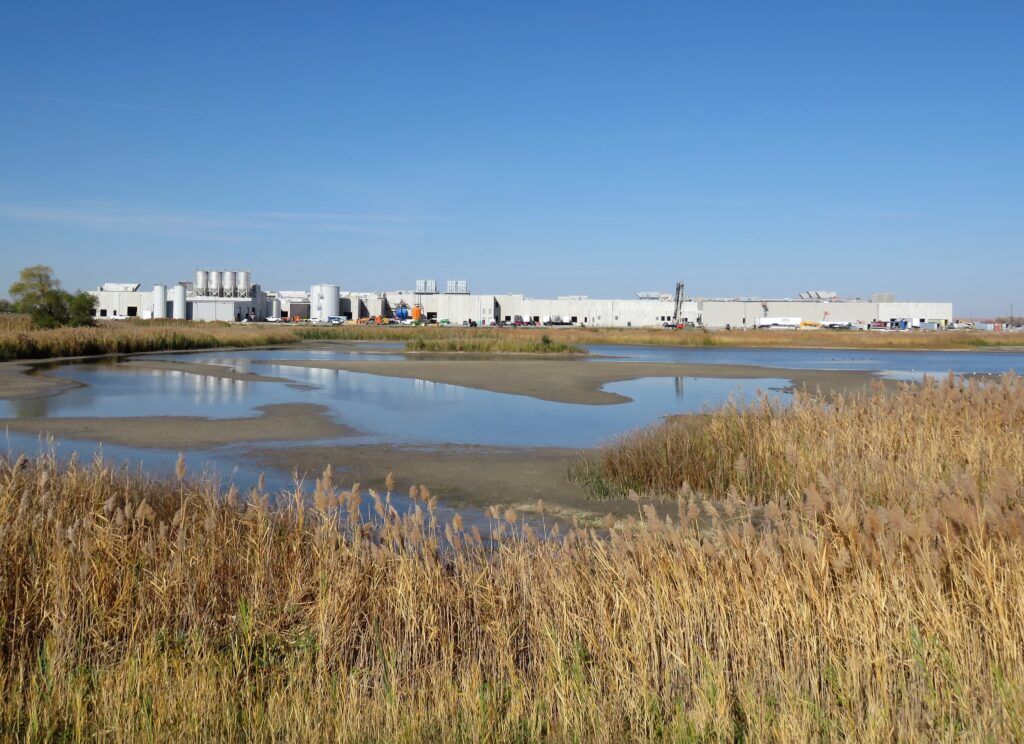 This image shows the full length of the massive Sustainable Beef plant’s south side, running from west to east. Once operational, the plant is expected to process 1,500 head of cattle, hauled in on 45 semi-trucks, each day. That’s roughly 1.5% of the nation’s fat cattle, says the company CEO.<br />(Lori Potter / Flatwater Free Press)