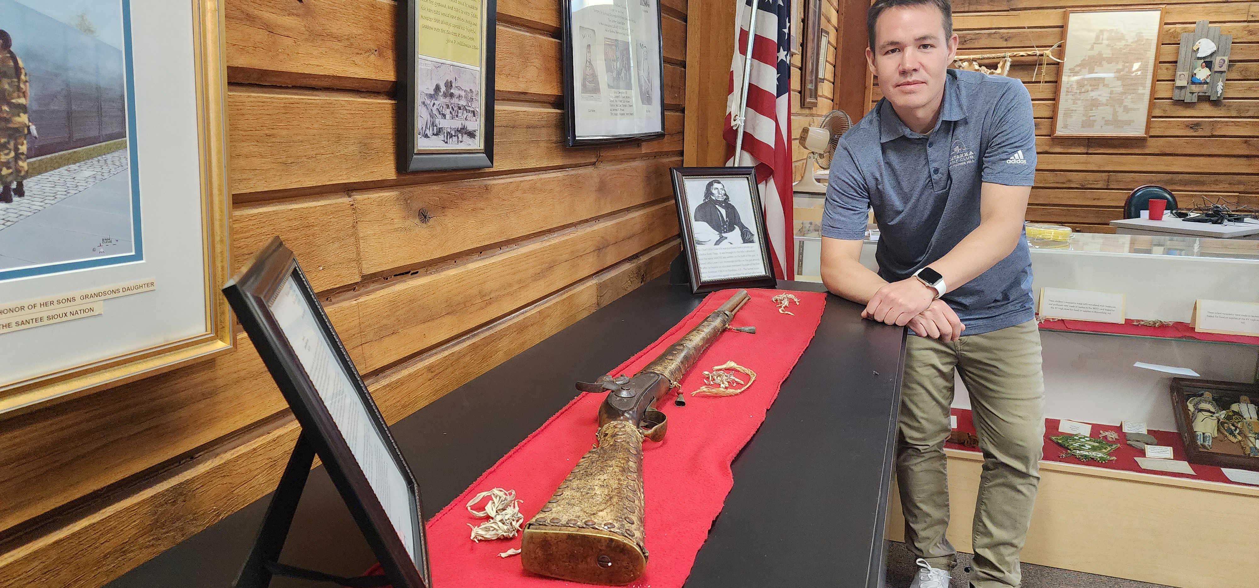 Santee Vice-Chairman Kameron Runnels poses with the rifle believed to have belonged to Chief Little Crow at the tribe’s museum. (Tim Trudell / Flatwater Free Press)
