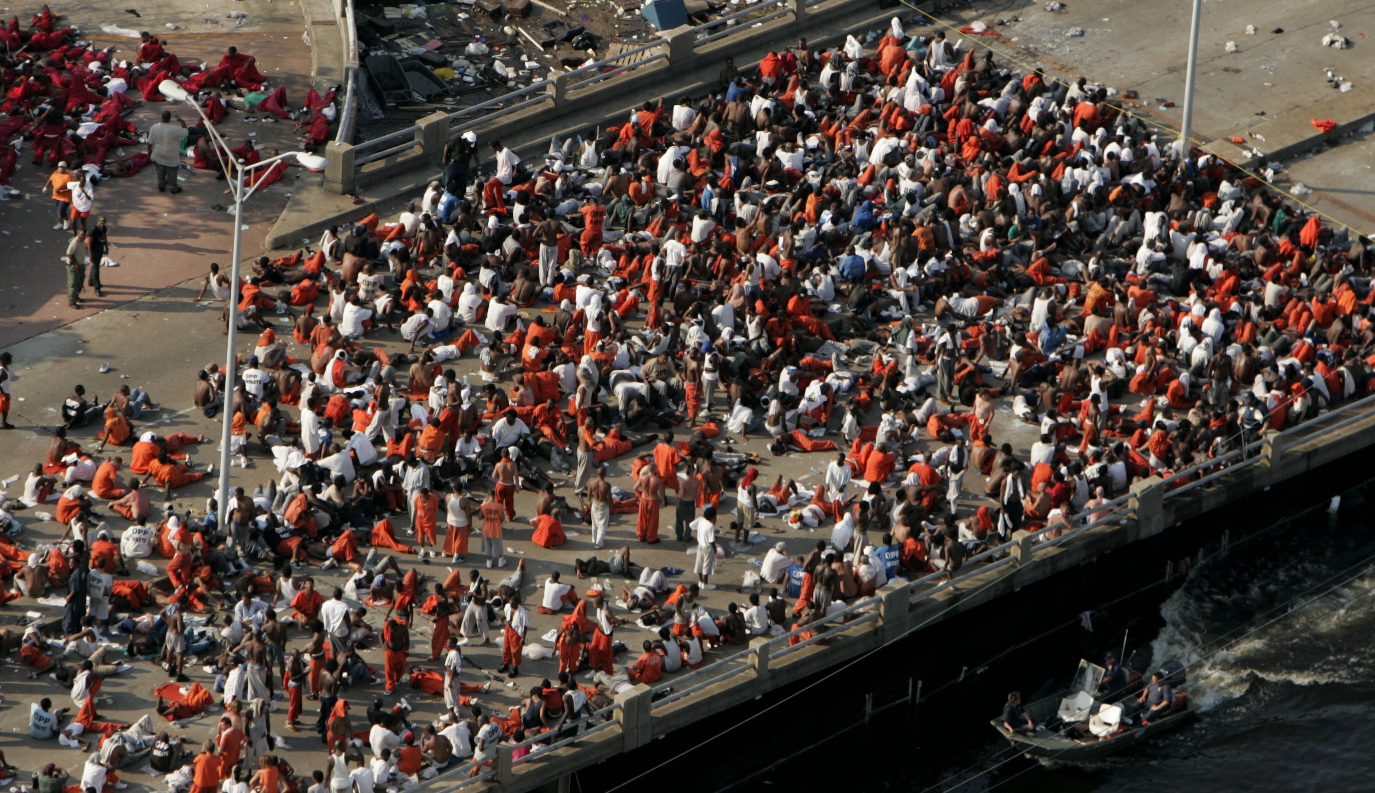 Prisoners from the Orleans Parish Prison wait to be evacuated from the flood waters as officials evacuate the city after Hurricane Katrina, Wednesday, Aug. 31, 2005, in New Orleans. Keynote speaker, Jason D. Williamson was motivated to advocate for a better system for public defense stating, “With this natural disaster, we were exposed to an ongoing constitutional disaster that is public defense in New Orleans.”<br />(Smiley N. Pool / The Dallas Morning News via AP)