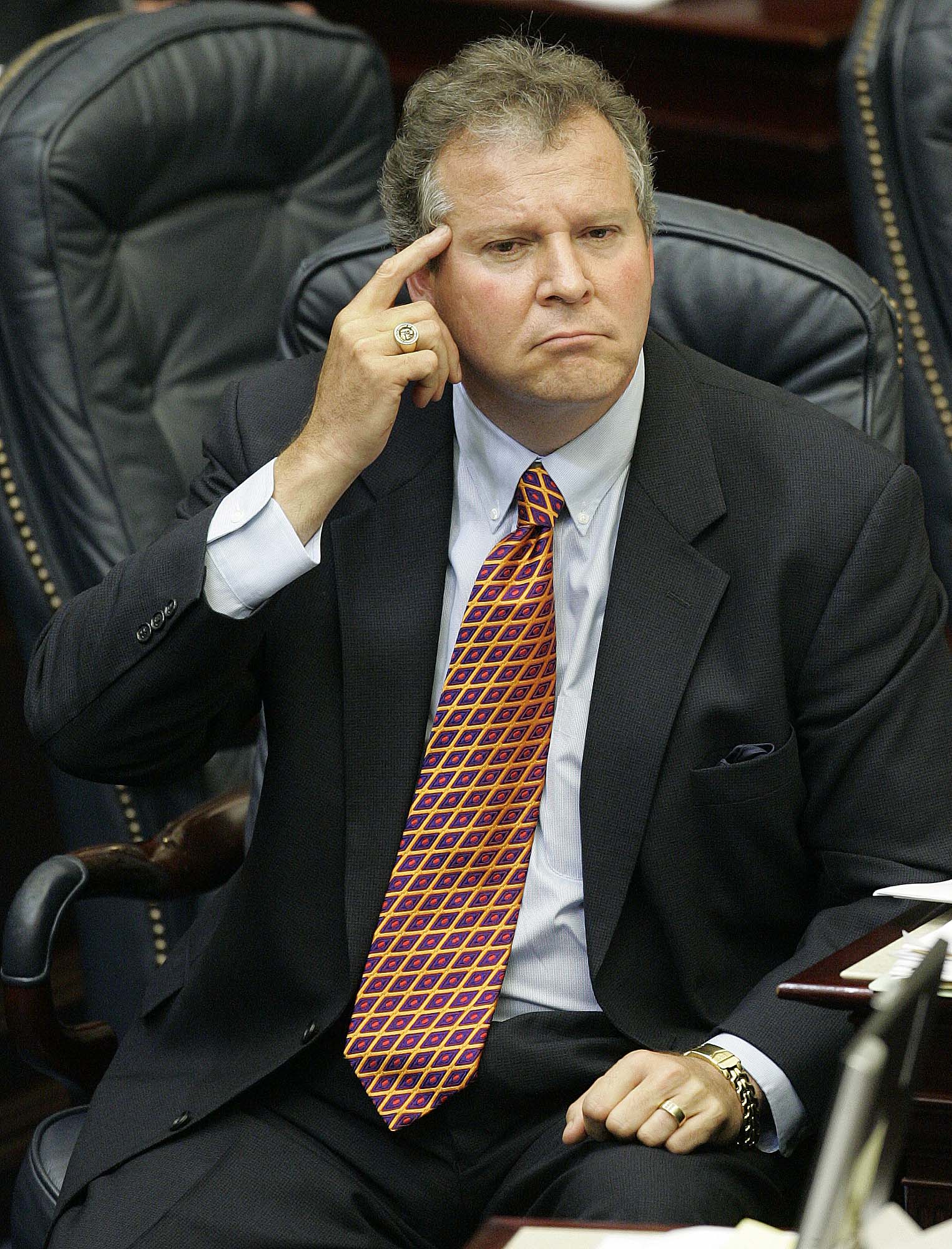 Rep. Randy Johnson, R-Celebration, points to his temple while sitting at his chamber desk during House session, Tuesday, May 2, 2006, in Tallahassee, Fla.<br />(Phil Coale / AP Photo)