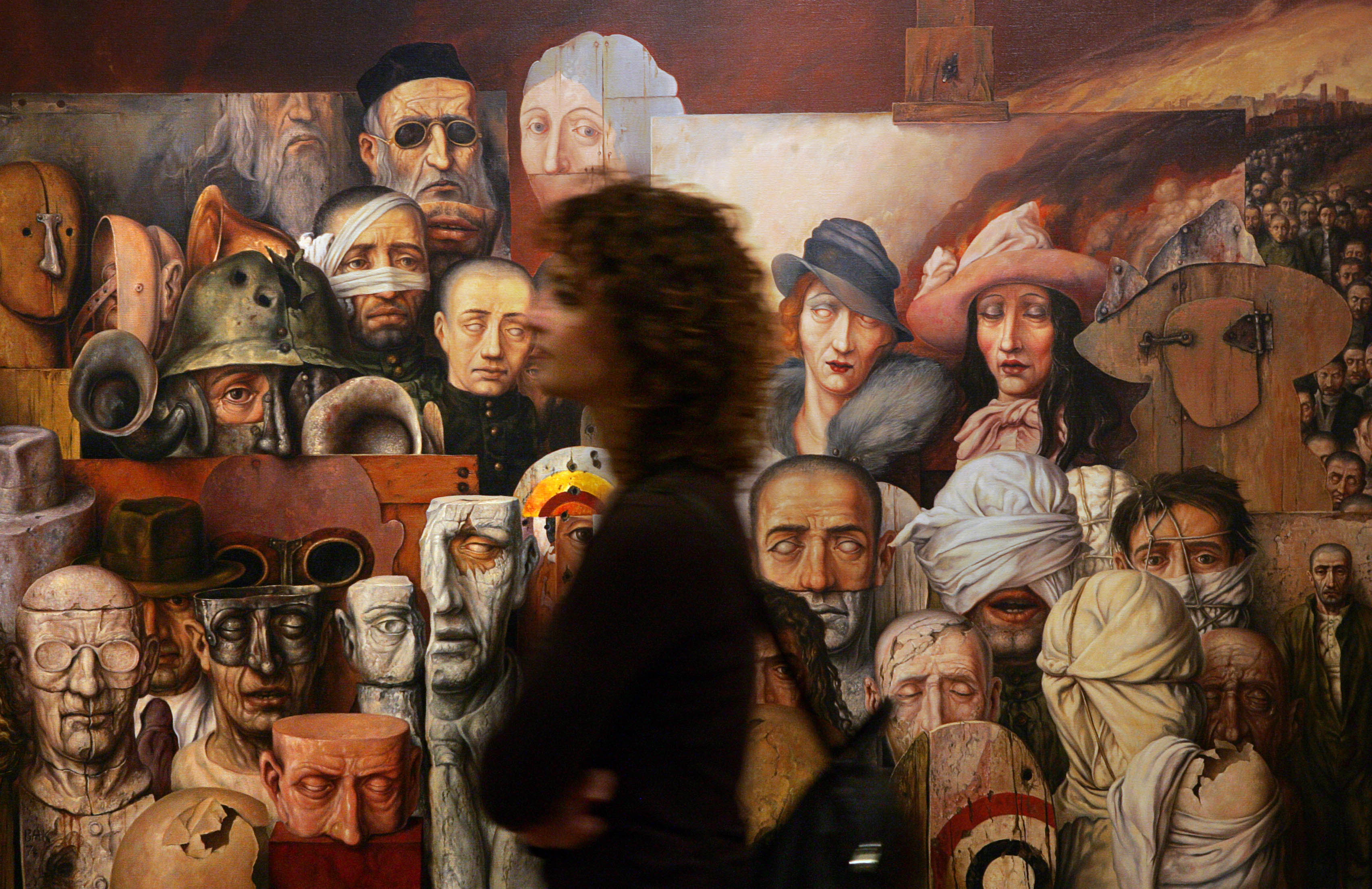 A woman walks past Samuel Bak’s painting “The Family” during the opening of his retrospective exhibition at the Yad Vashem Holocaust Memorial in Jerusalem, Friday, Dec. 8, 2006. Bak, born in Lithuania in 1933, is a survivor of the Vilna Ghetto and now lives in the US.<br />(Kevin Frayer / AP Photo)