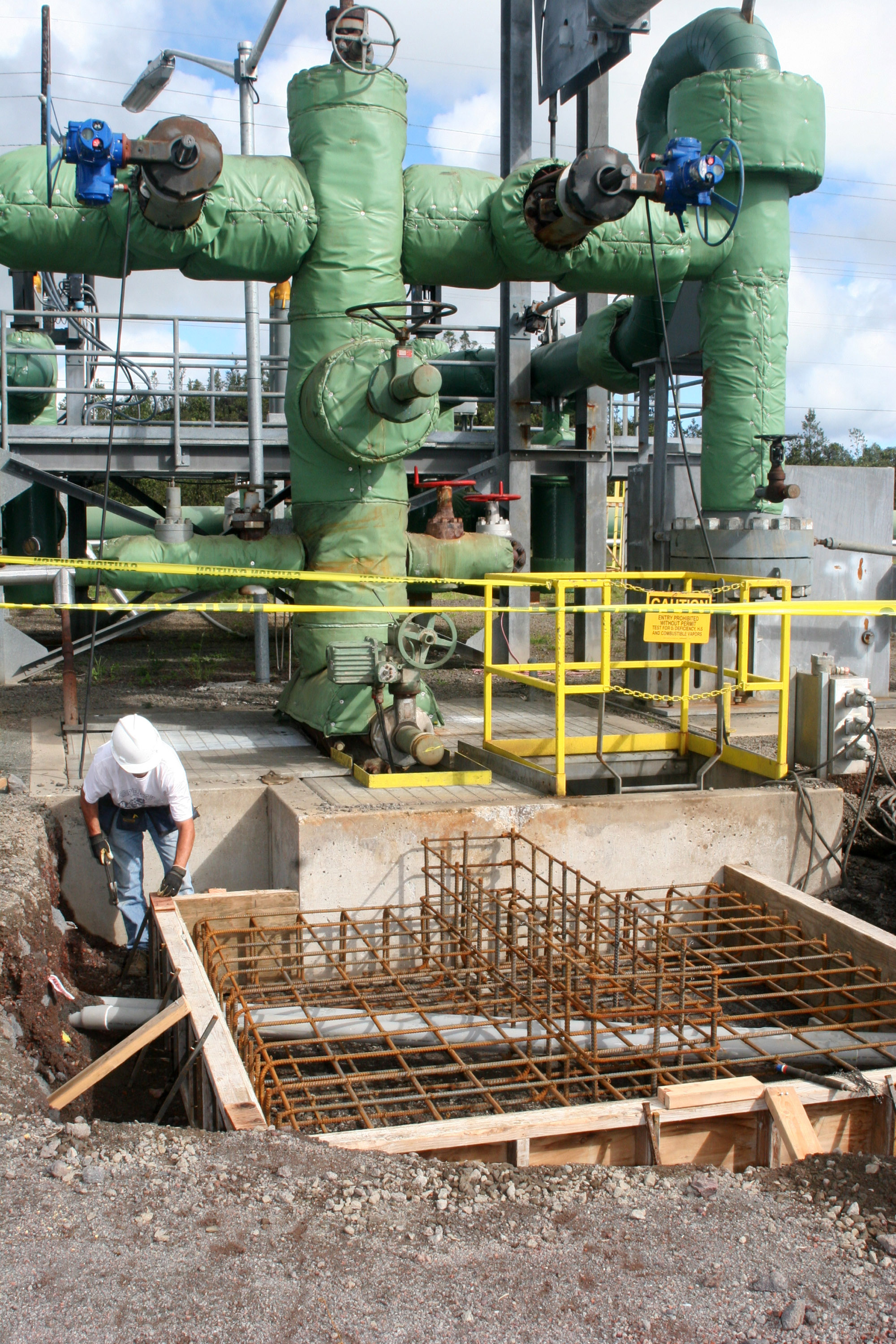 A construction crew member is shown March 6, 2007 working near well #6 at Puna Geothermal Venture, in Puna, Hawaii. Hawaii seems like a perfect candidate for energy independence because its Pacific gusts, ample sunlight and a continuously erupting volcano can be used to make natural electricity.<br /> (Tim Wright / AP Photo)