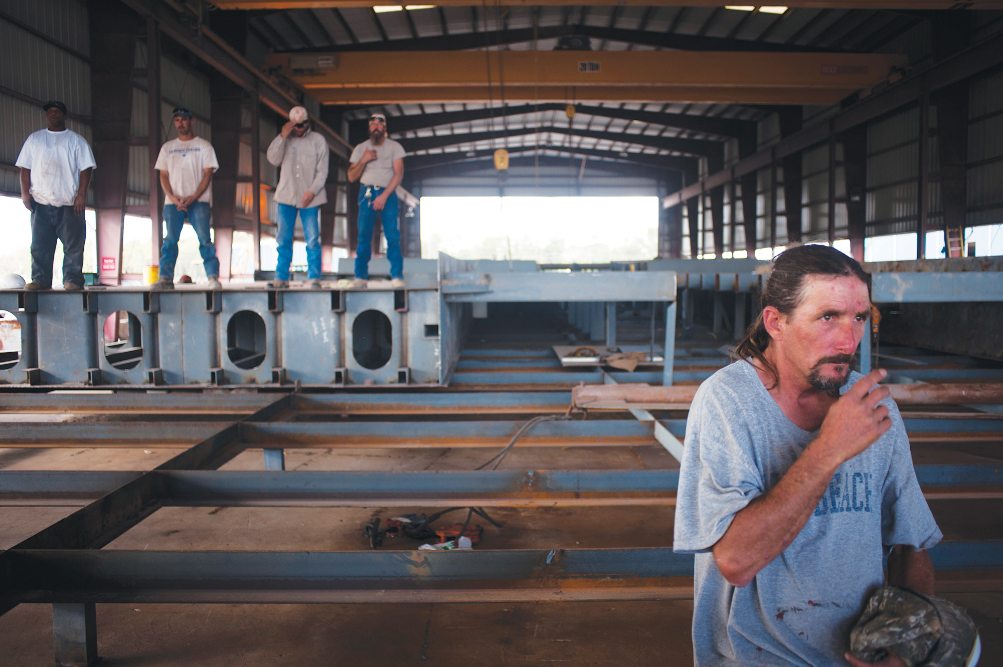 Employees of Thoma-Sea Ship Builders pray at the beginning of the christening ceremony at the Port of Terrebonne on Tuesday, Oct. 11, 2011 in Houma, LA.<br />(Michael Conti / The Houma Daily Courier via AP)