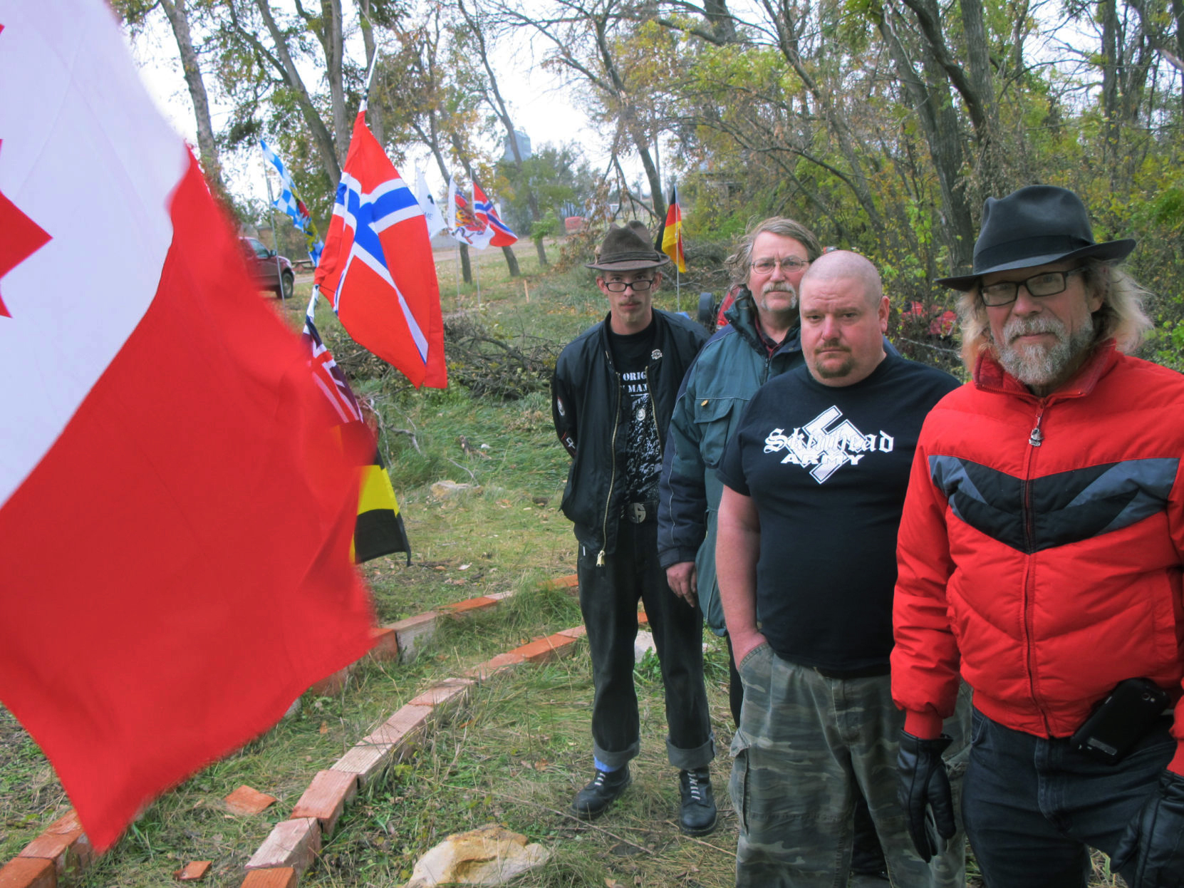 In this Oct. 30, 2013 photo, Craig Cobb (right) with supporters Mike Spence, of Goodrich, Albert Borgmann, of Minot, and Kynan Dutton, of Oregon, who arrived to help him create an all white community in Leith, N.D.<br /> (Lauren Donovan / The Bismarck Tribune via AP)