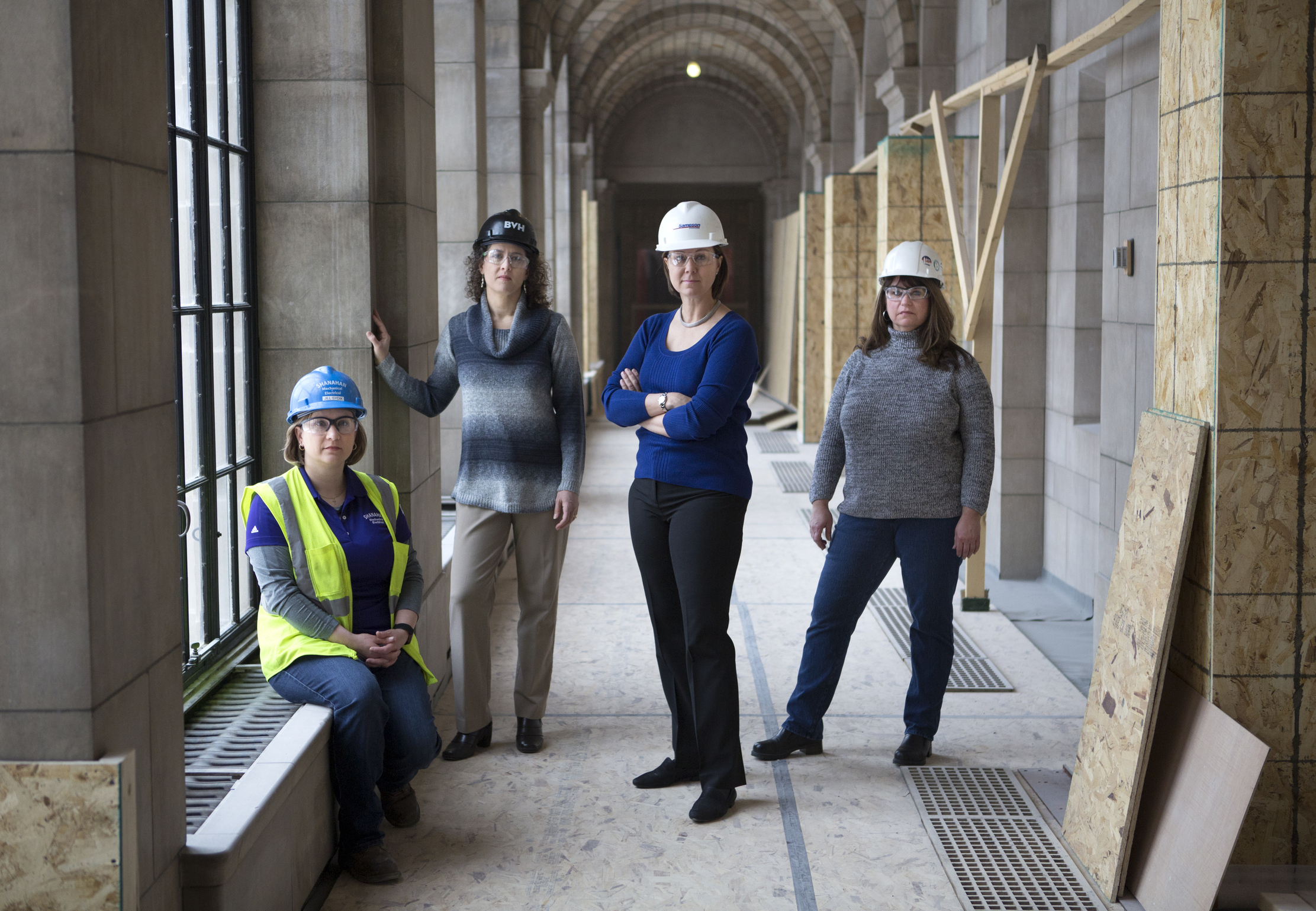In this March 7, 2019, photo from left: Jill Sydik of Shanahan Mechanical and Electrical, Julie Cawby, historical architect with BVH Architecture, Cori Vokoun, vice president of Sampson Construction, and Chris Bockmann, president of Bockmann Inc., pose for a photo at the Nebraska Capitol in Lincoln, Neb.<br /> (James Wooldridge / Lincoln Journal Star via AP)