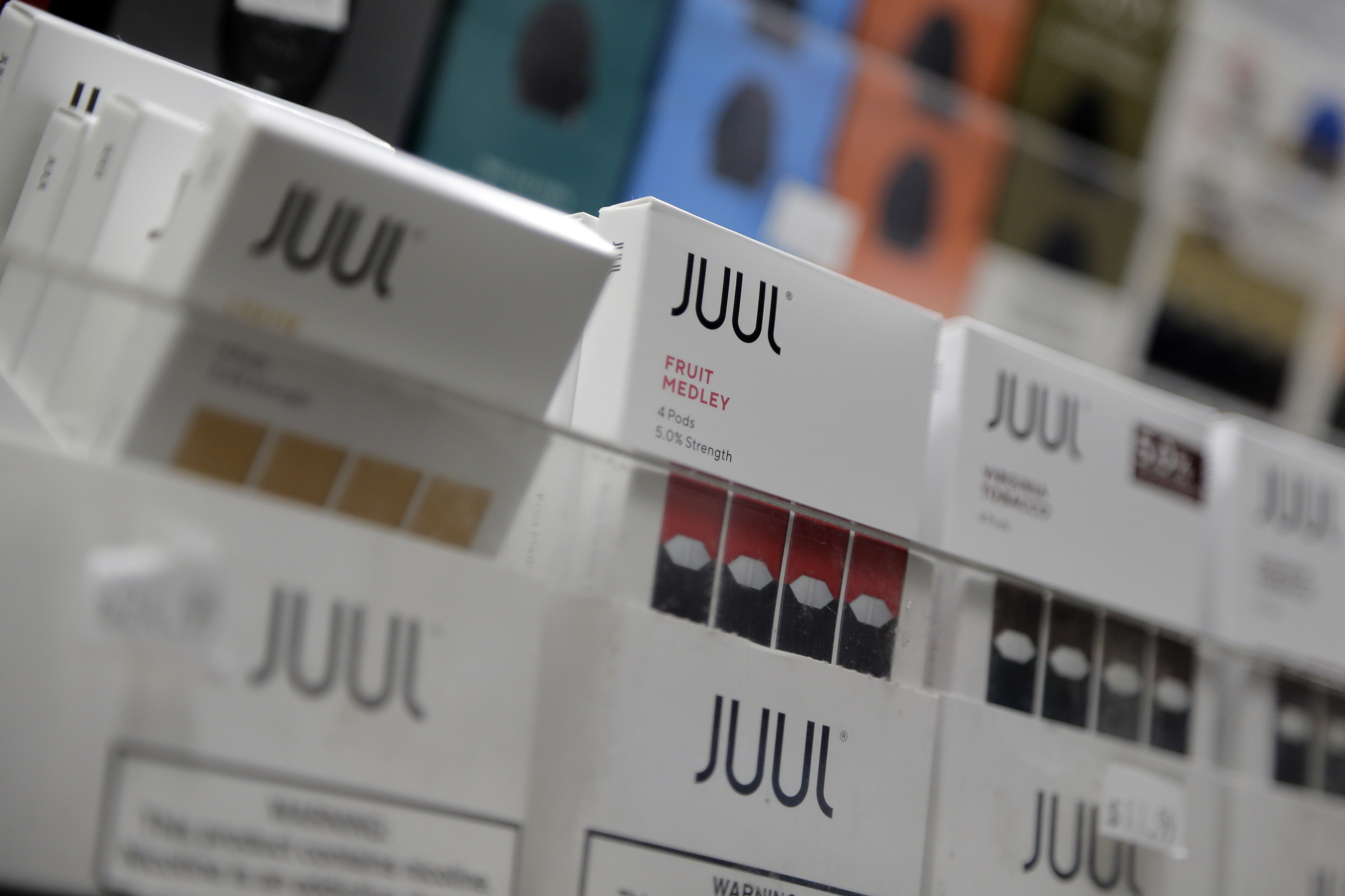 Juul products are displayed at a smoke shop in New York. Under scrutiny amid a wave of underage vaping, Juul is pushing into television with a multimillion-dollar campaign rebranding itself as a stop-smoking aid for adults trying to kick cigarettes.<br />(Seth Wenig / AP Photo)