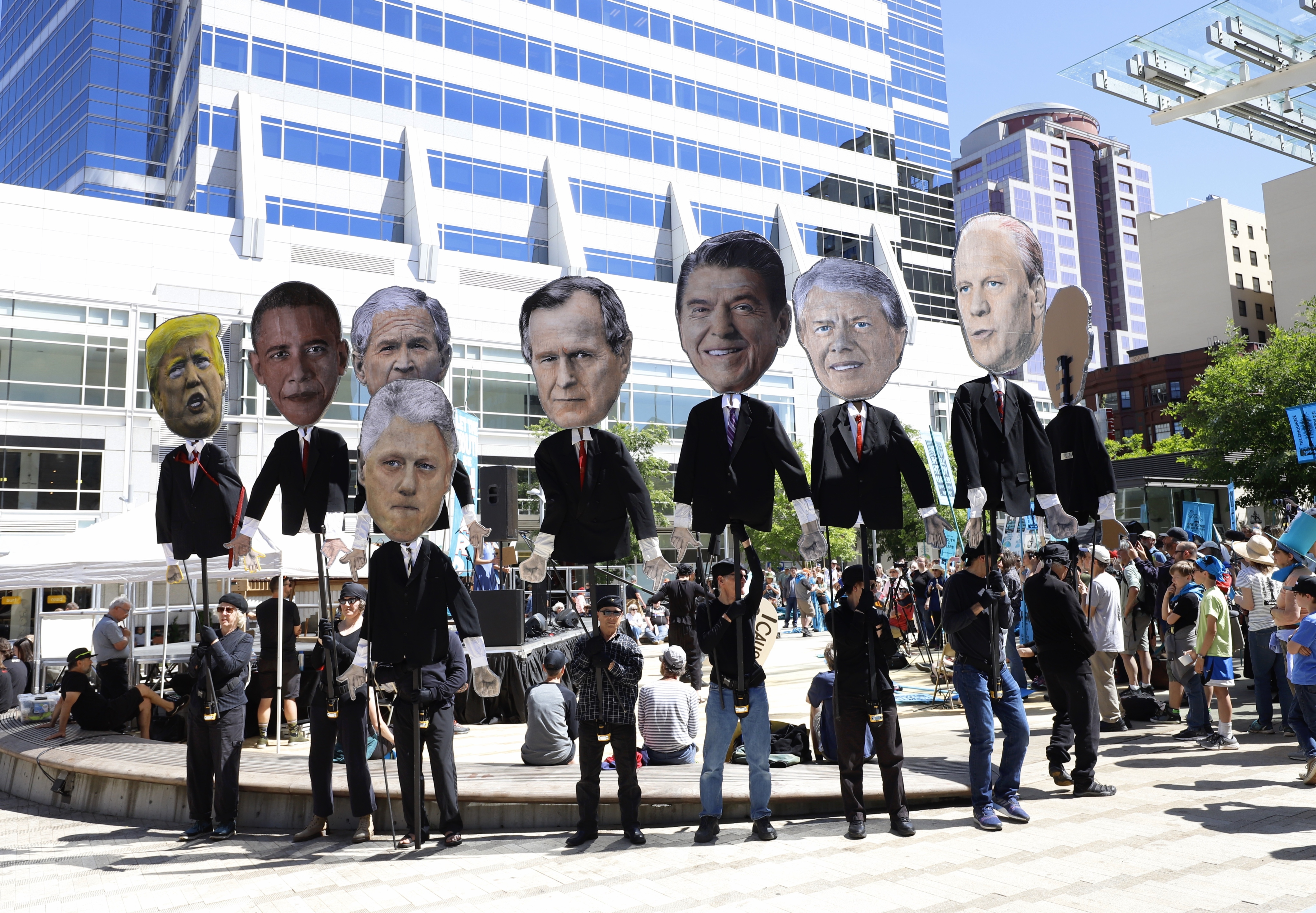 Supporters hold caricatures of U.S. presidents at a rally for a group of young people who filed a lawsuit saying U.S. energy policies are causing climate change and hurting their future. The group faces a major hurdle Tuesday as lawyers for the Trump administration argue to stop the case from moving forward. in Portland, Ore., Tuesday, June 4, 2019.<br />(Steve Dipaola / AP Photo)