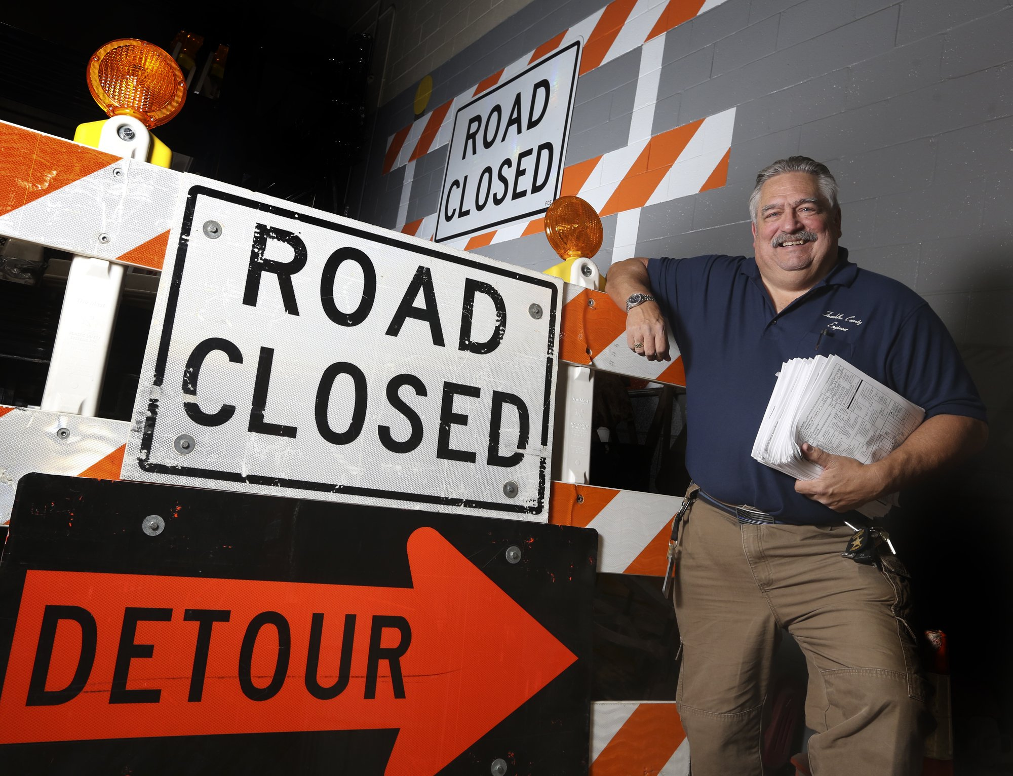 In this Nov. 25, 2019, photo, Dave McMannis, first responder liaison with the Franklin County Engineers office, poses for a photo at the Franklin County Engineers office in Columbus, Ohio. He is responsible for contacting schools, emergency responders and others to coordinate traffic before construction projects start.<br />(Eric Albrecht / The Columbus Dispatch via AP)