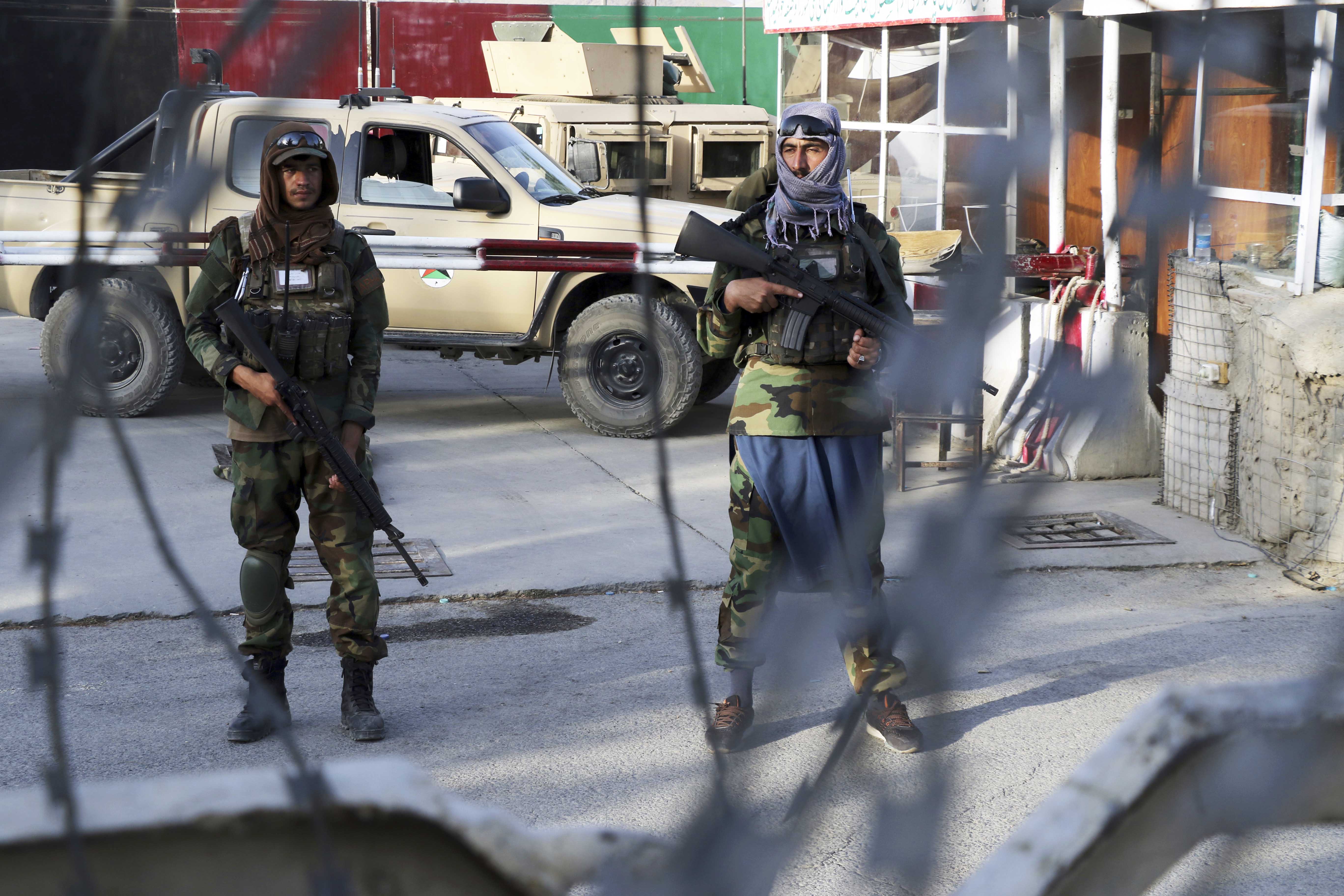 Taliban fighters stand guard at a checkpoint near the gate of Hamid Karzai international Airport in Kabul, Afghanistan, during the U.S. withdrawal in August 2021. The Taliban’s return to power led some Afghans to make a dangerous trip to the U.S. southern border to seek asylum.<br />(Wali Sabawoon / AP Photo)