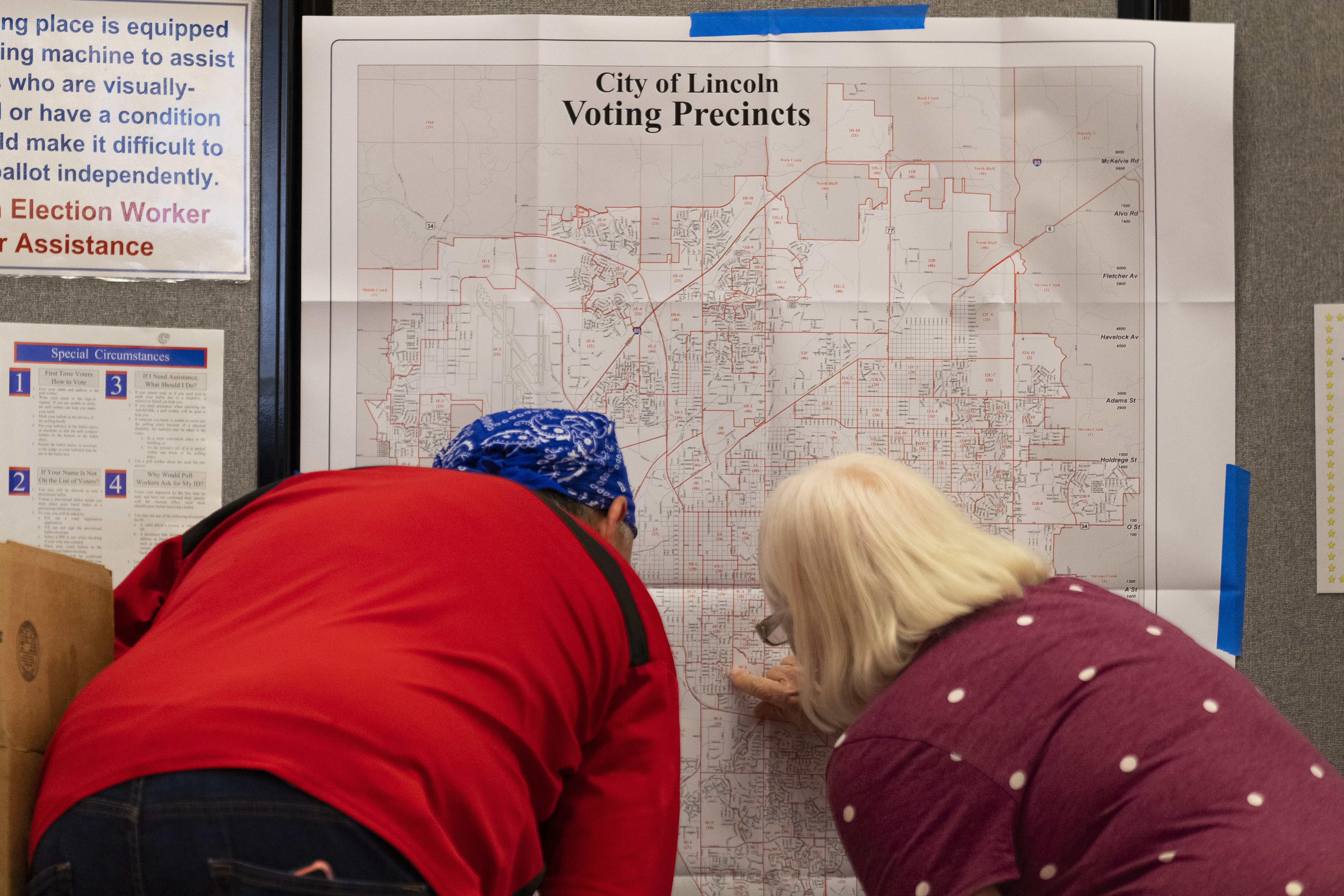 Terri Rotolo Hatch (right) helps a voter find their voting location at the Union at the University of Nebraska on Tuesday, May 10, 2022, in Lincoln, Neb.<br /> (Kenneth Ferriera / Lincoln Journal Star via AP)