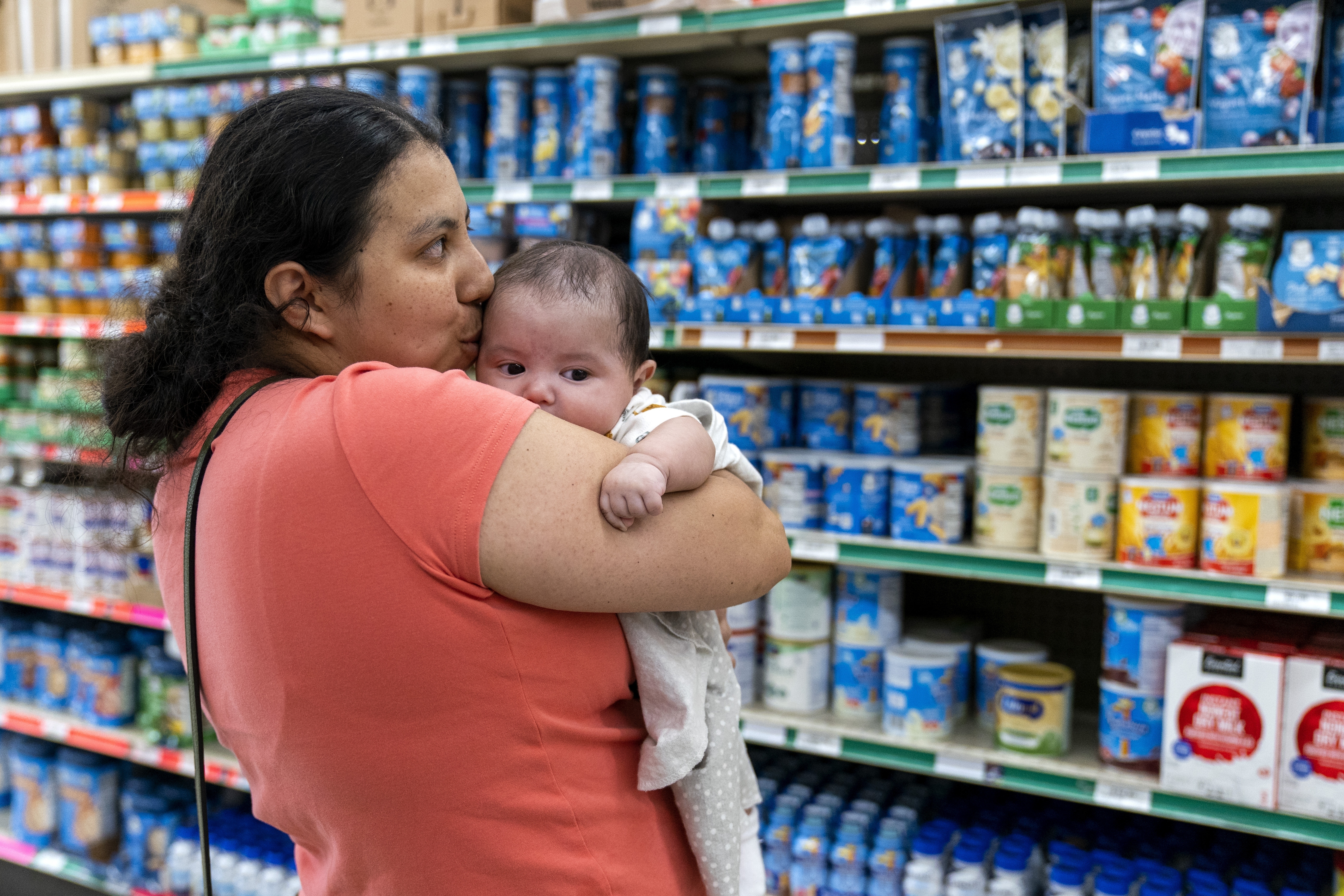 Yury Navas, 29, of Laurel, Md., kisses her two-month-old baby at Superbest International Market in Laurel, Md., Monday, May 23, 2022, while looking for formula. After this day&#039;s feedings she will be down to the last 12.5 ounce container. The only formula he can take without digestive issues, Enfamil Infant, has been almost impossible for her to find.<br />(Jacquelyn Martin / AP Photo)