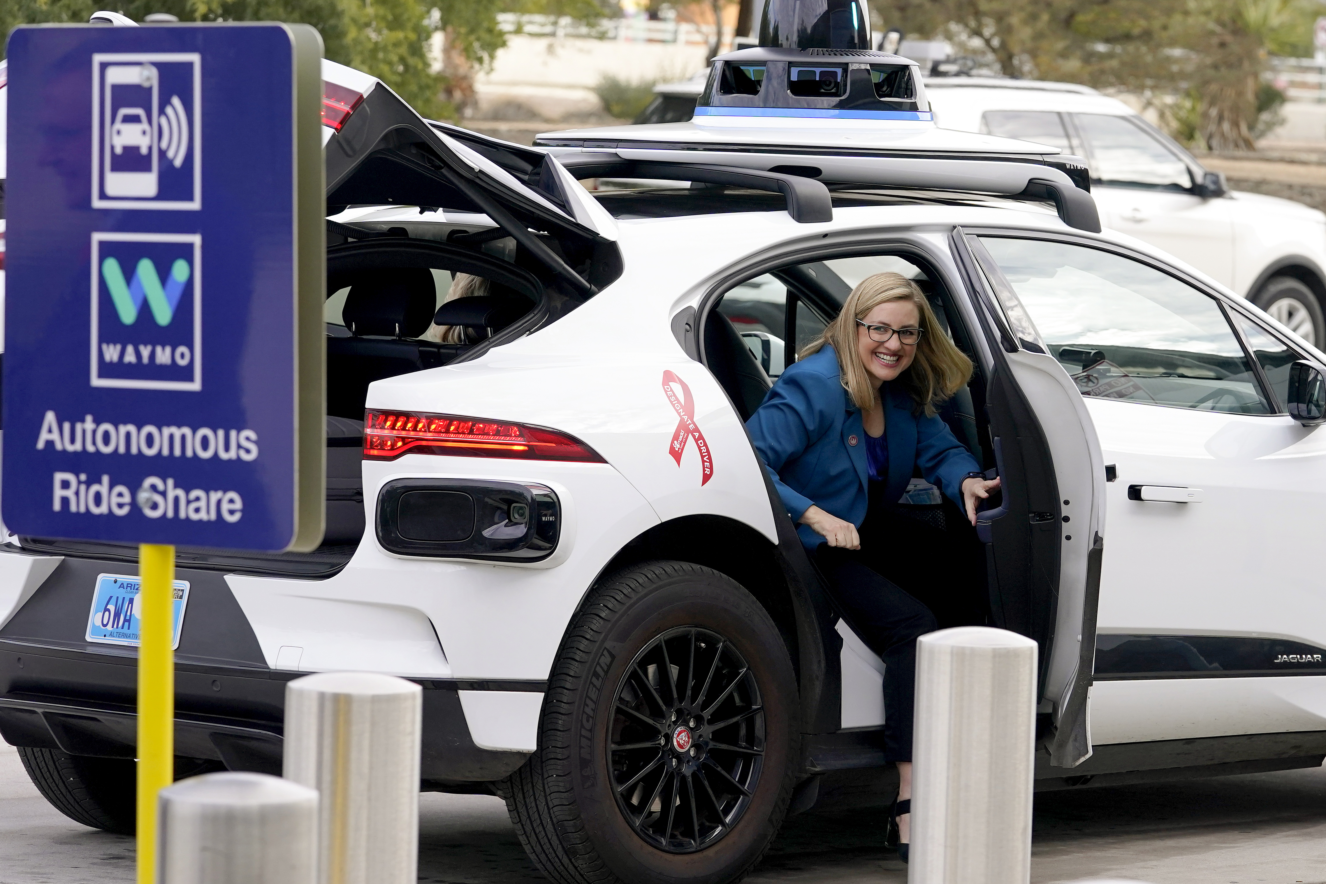 Phoenix Mayor Kate Gallego arrives in a Waymo self-driving vehicle on Dec. 16, 2022, at the Sky Harbor International Airport Sky Train facility in Phoenix. Self-driving car pioneer Waymo announced Thursday, May 4, 2023, that its robotaxis will be able to carry passengers through most of the Phoenix area for the first time.<br />(Matt York / AP Photo)