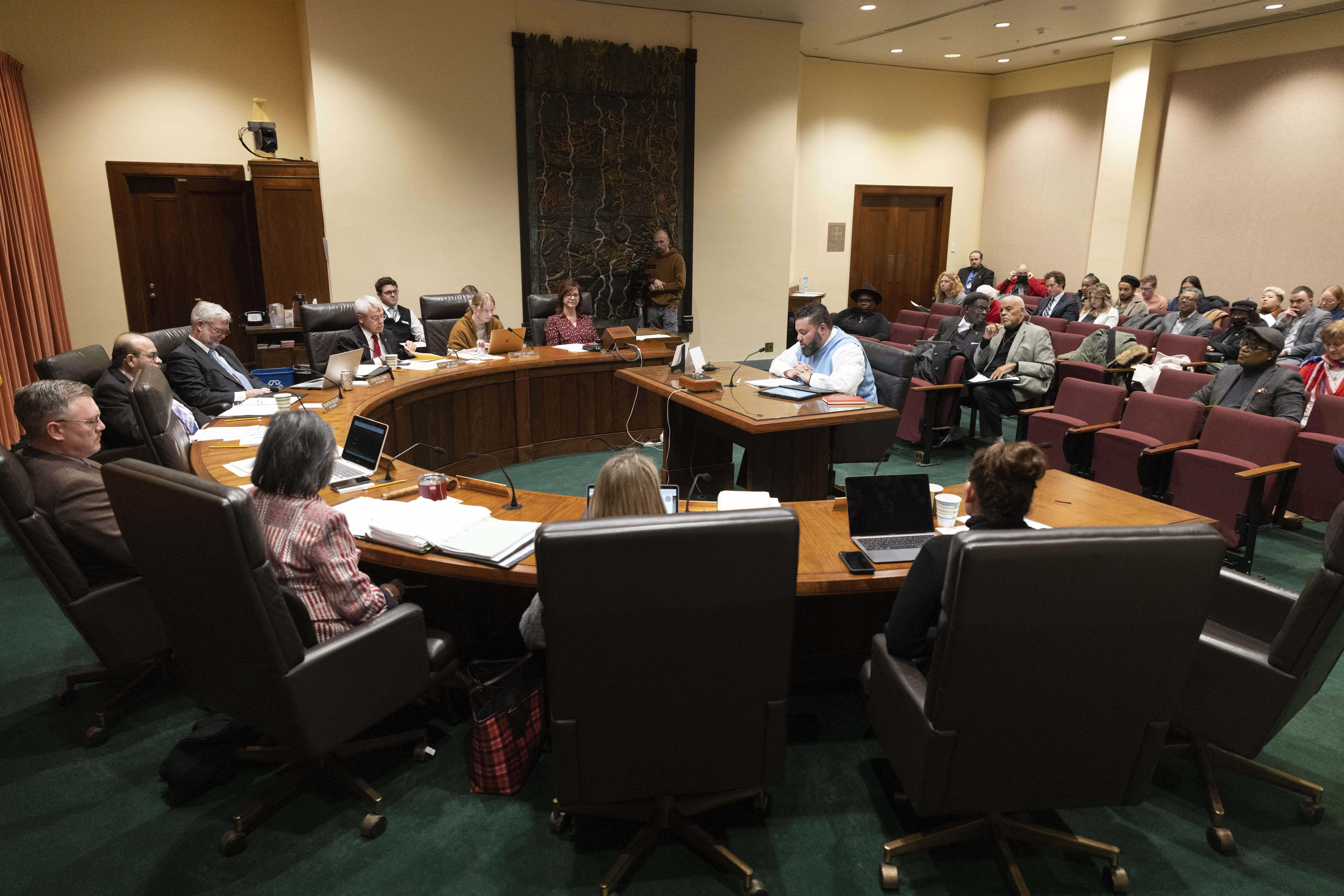 Nebraska state Sen. Justin Wayne (center) speaks on behalf of LB20, a bill he introduced, during a hearing before the Government, Military and Veterans Affairs Committee on Feb. 22, 2023, at the Nebraska State Capitol in Lincoln, Neb.<br />(Rebecca S. Gratz / AP Photo