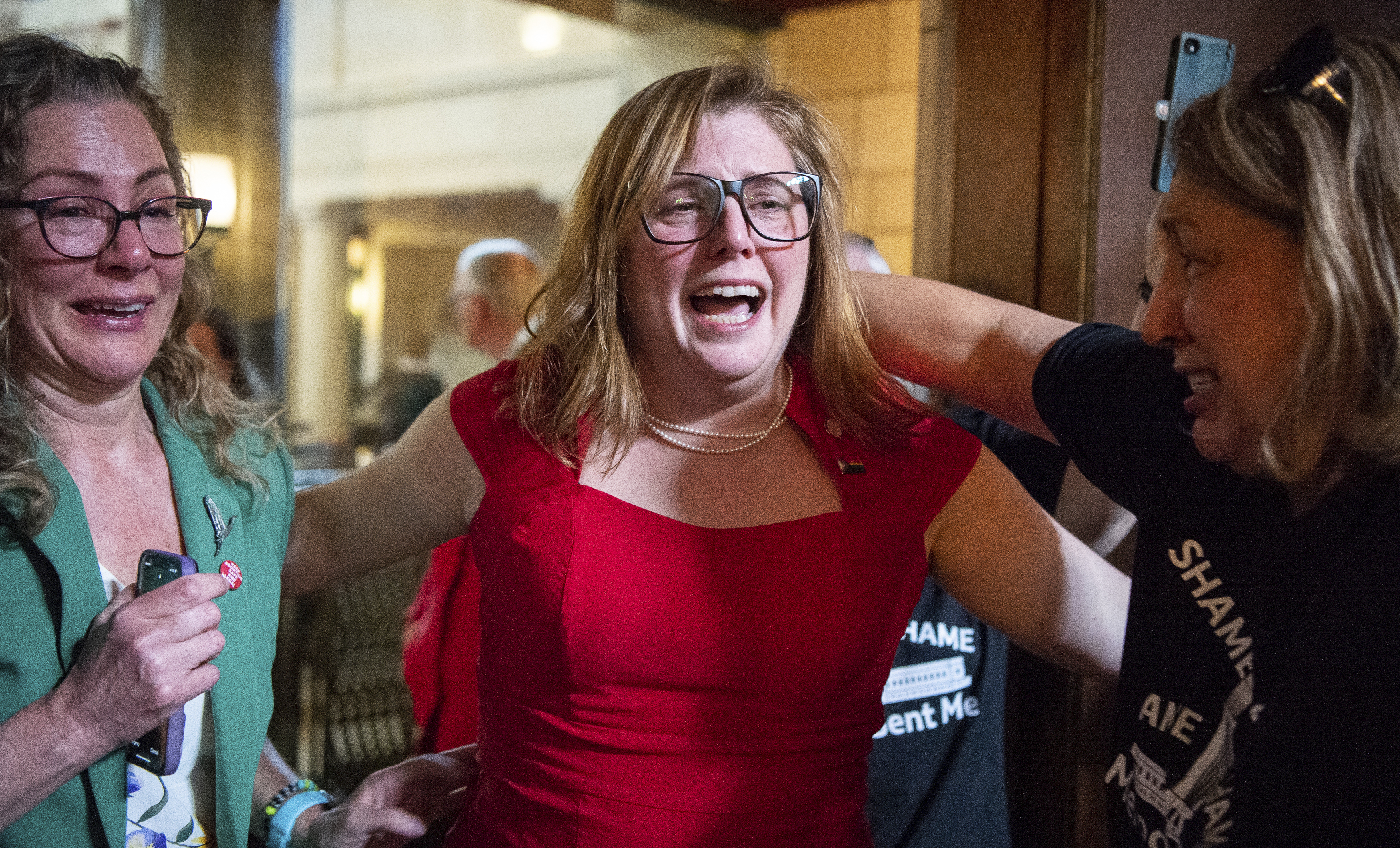 State Sen. Machaela Cavanaugh, center, hugs supporters, April 27, 2023, at the Nebraska State Capital in Lincoln, Neb. The Nebraska Legislature has long prided itself on being a paragon of collegiality and function, as the only single-chamber, nonpartisan Legislature in the country. But after a vicious 2023 session in which the body of 49 lawmakers remained irreconcilably split, Nebraska’s statehouse is beginning to reflect broad, national discord. (Larry Robinson / Lincoln Journal Star via AP)