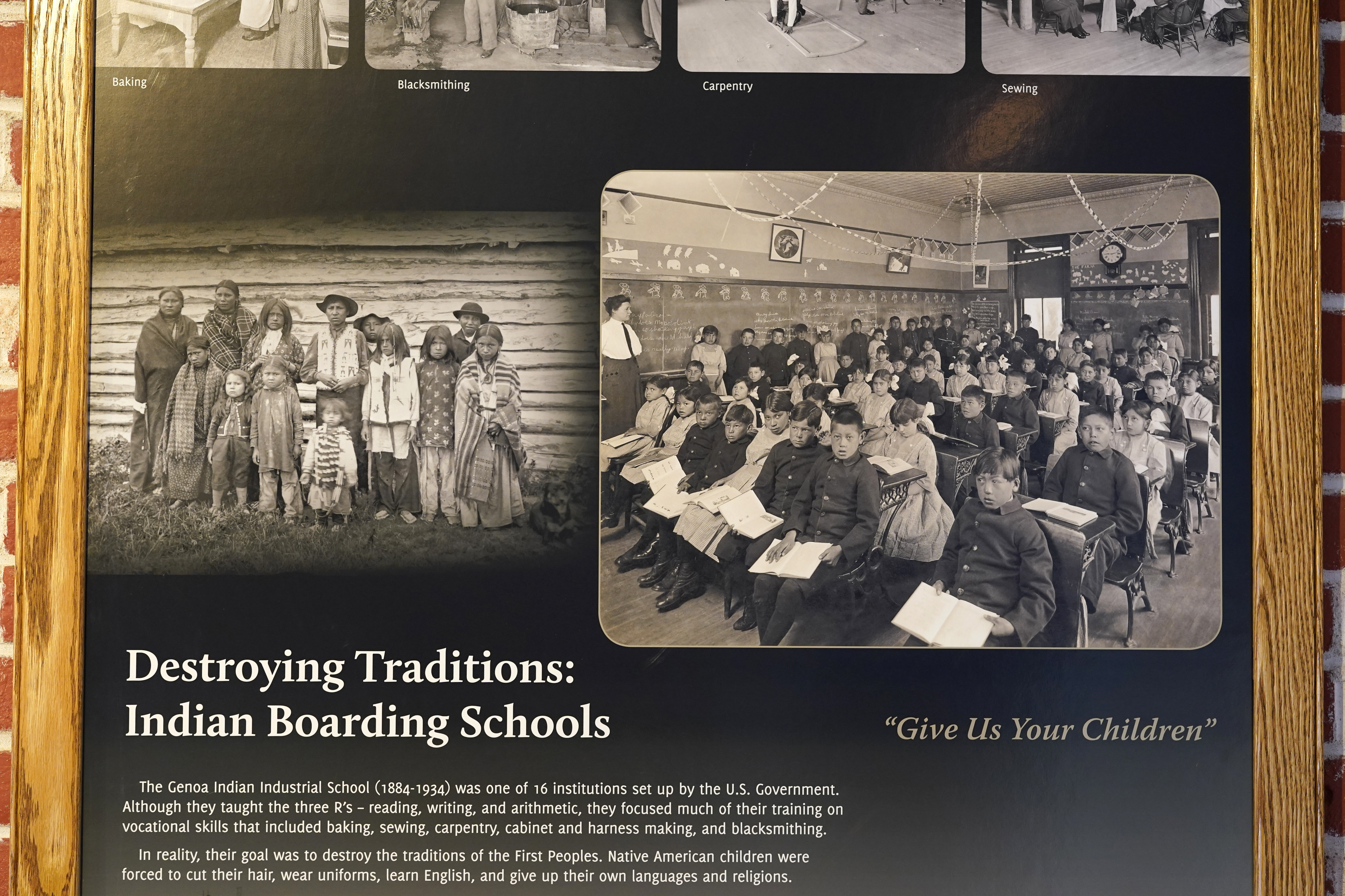 Photos of students in a classroom are seen on display in a museum at the former Genoa Indian Industrial School, Thursday, Oct. 27, 2022, in Genoa, Neb. For decades the location of the student cemetery, where over 80 Native American children are buried, has been a mystery, lost over time after the school closed in 1931 and memories faded of the once-busy campus that sprawled over 640 acres in the tiny community of Genoa. (Charlie Neibergall / AP Photo)
