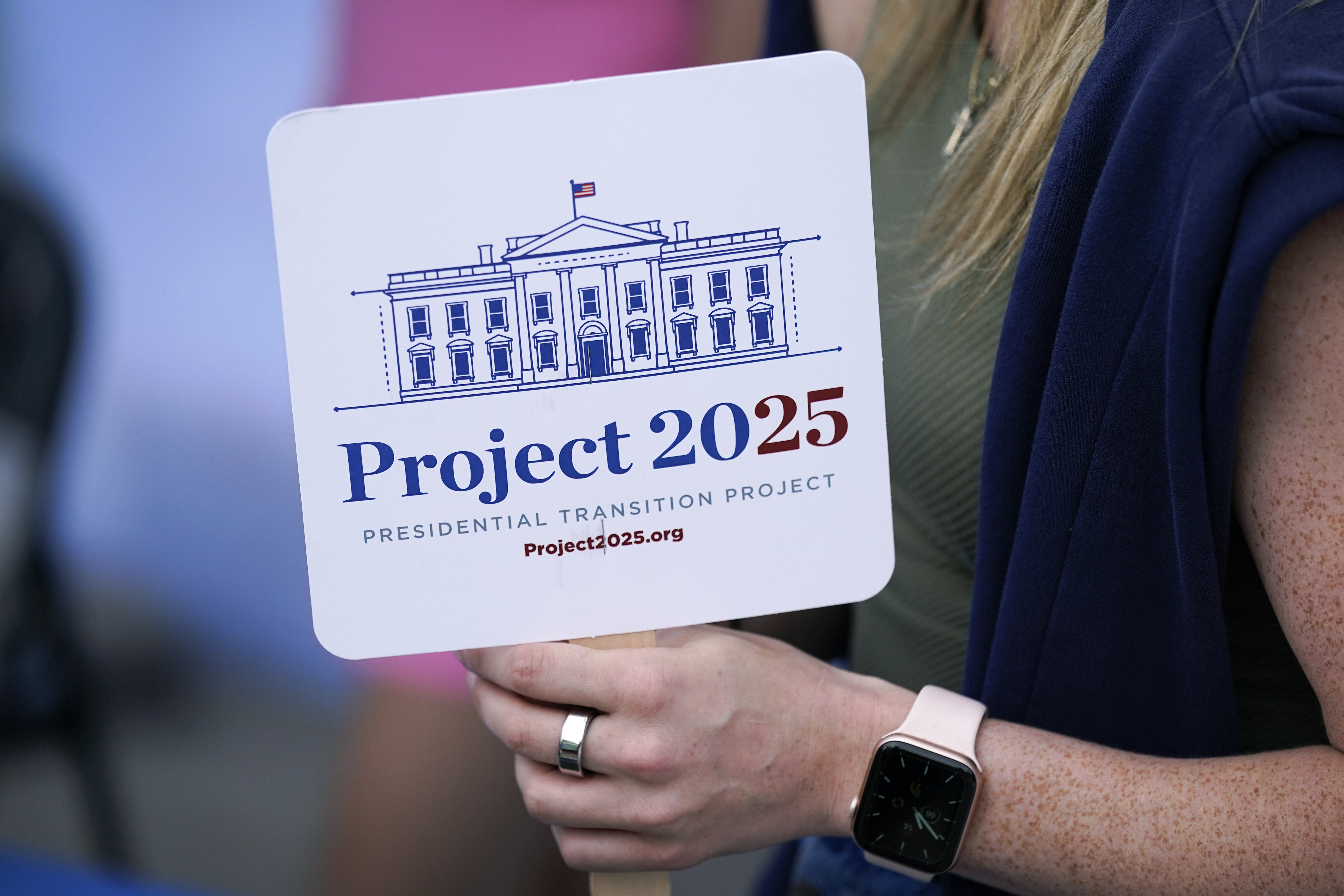 Kristen Eichamer holds a Project 2025 fan in the group&#039;s tent at the Iowa State Fair, Aug. 14, 2023, in Des Moines, Iowa. A constellation of conservative organizations is preparing for a possible second White House term for Donald Trump. The Project 2025 effort is being led by the Heritage Foundation think tank.<br />(Charlie Neibergall / AP Photo)
