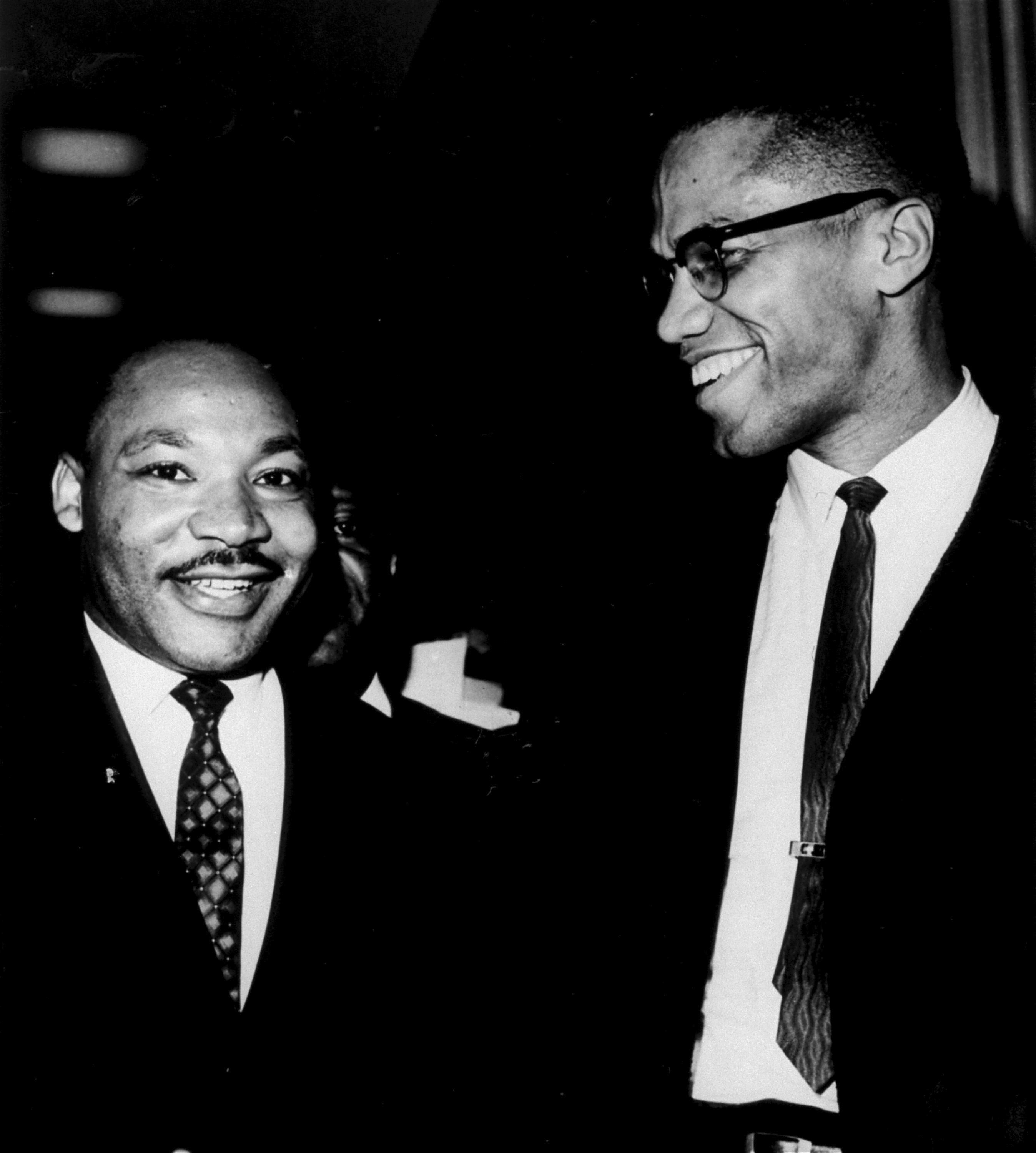 The Rev. Martin Luther King, Jr. (left) of the Southern Christian Leadership Conference, and Malcolm X, head of a new group known as Muslim Mosque, Inc., smile for photographers March 26, 1964, at the Capitol.<br />(Henry Griffin / AP Photo)