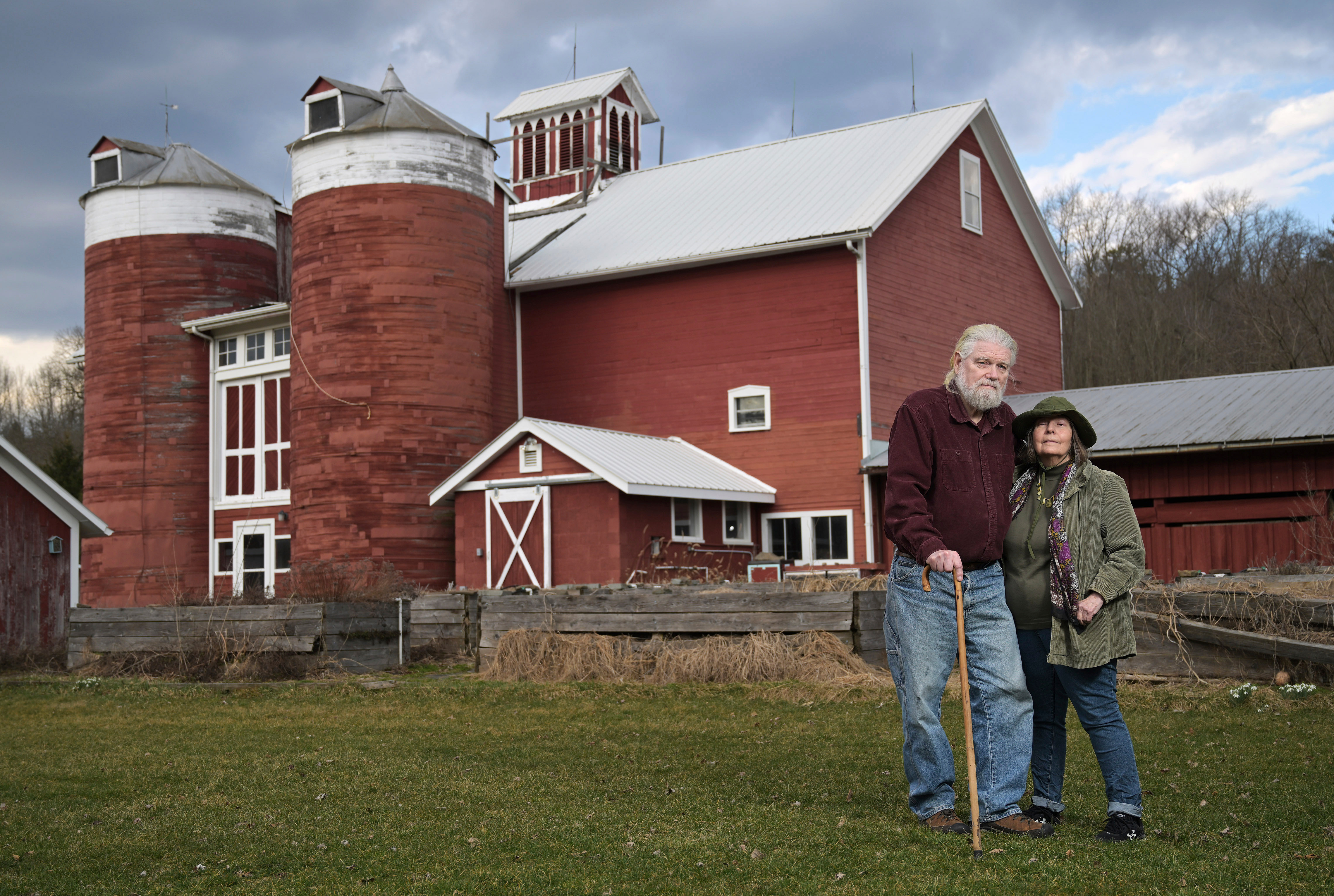 Joan and Harold Koster pose for a photo in front of a historic barn on their property, known as Itaska Valley Farm, Wednesday, March 13, 2024, in Whitney Point, N.Y. The Kosters were asked by Texas-based Southern Tier Energy Solutions to lease their land to extract natural gas by injecting carbon dioxide into the ground, which they rejected and are opposed to.<br />(Heather Ainsworth / AP Photo)