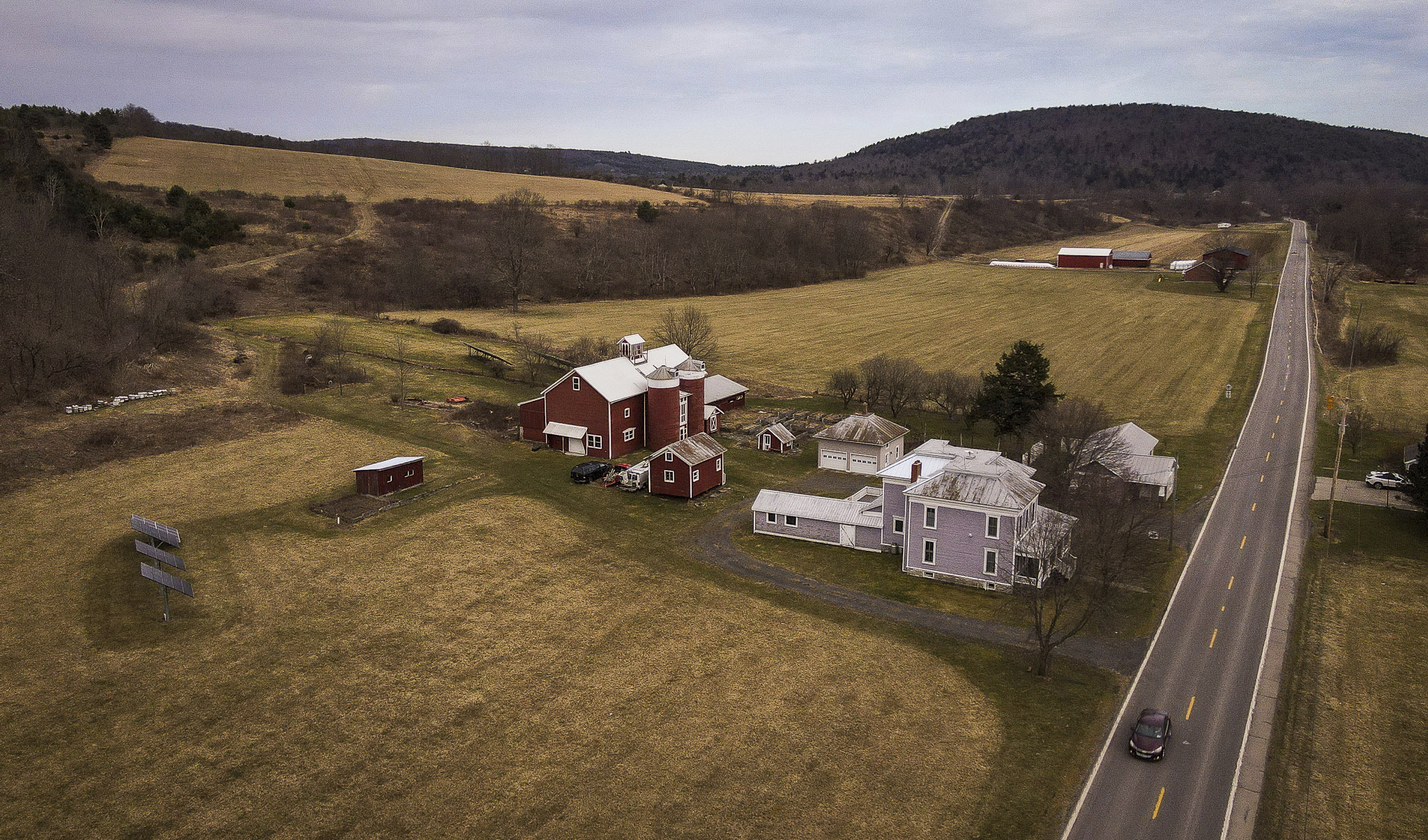 A car passes the Itaska Valley Farm, owned by Joan and Harold Koster, Wednesday, March 13, 2024, in Whitney Point, N.Y.<br />(Heather Ainsworth / AP Photo)