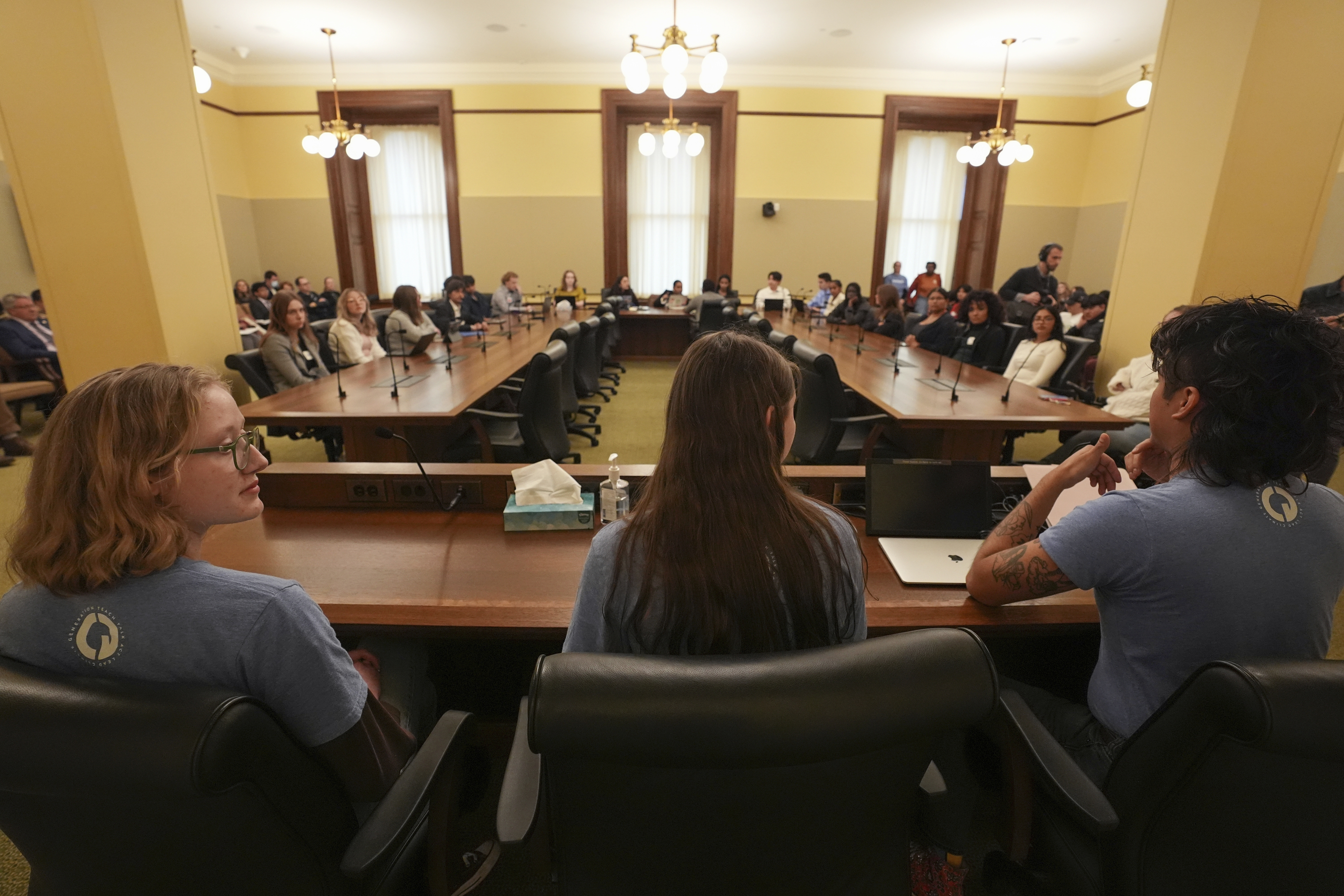 Libby Kramer, left, Lucia Everist, center, and B Rosas, of Climate Generation, speak to the Minnesota Youth Council, Tuesday, Feb. 27, 2024, in St. Paul, Minn. The advocates called on the council, a liaison between young people and state lawmakers, to support a bill requiring schools to teach more about climate change.<br />(Abbie Parr / AP Photo)