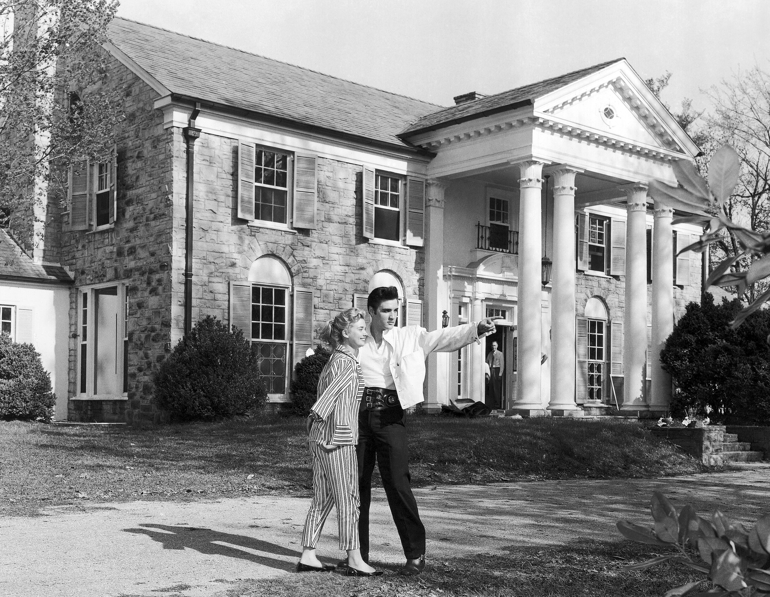 Elvis Presley with his girlfriend Yvonne Lime are photographed at his home, Graceland, in Memphis, Tenn., around 1957. A mysterious company has caused a stir for trying to auction Elvis Presley&#039;s Graceland in a foreclosure sale this week. A judge has blocked the sale after Presley&#039;s granddaughter filed a lawsuit alleging fraud.<br />(AP Photo)