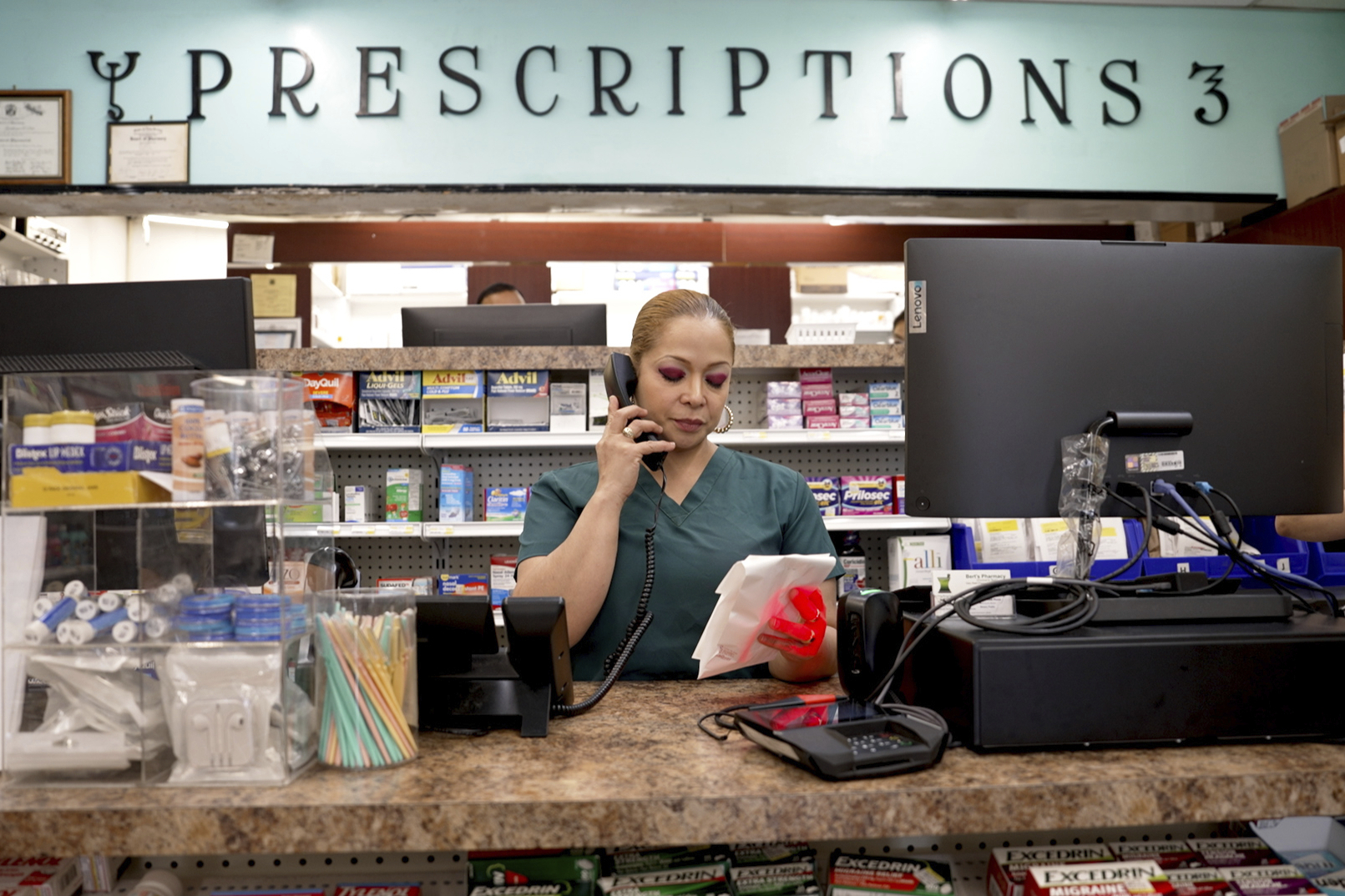 Carmen Lopez works at Bert’s Pharmacy in Elizabeth, N.J., on May 21, 2024. The business is located in an ZIP code where nearly 70% of the residents are Hispanic.<br />(Shelby Lum / AP Photo)