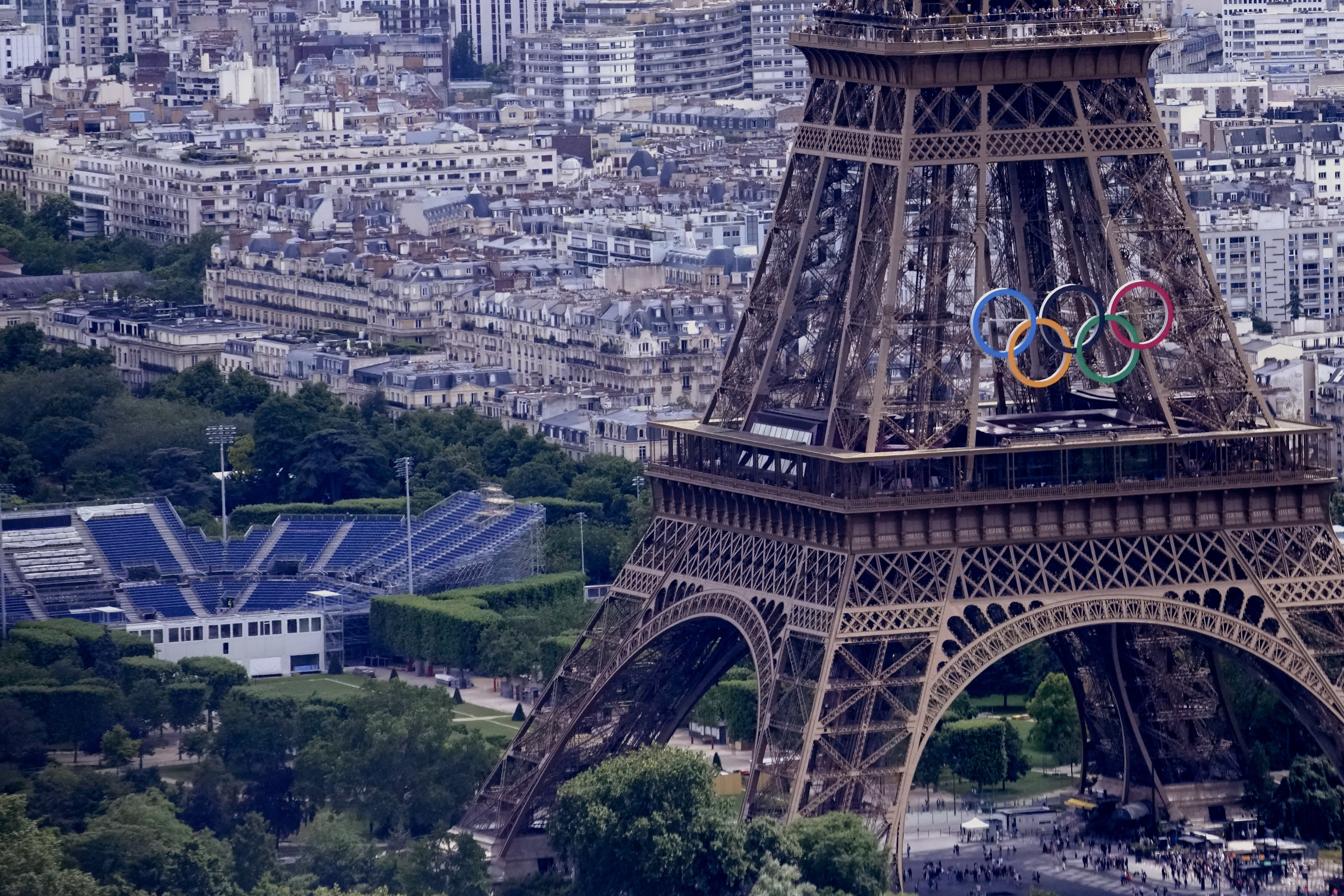 The Olympic rings are seen on the Eiffel Tower in Paris, France, Monday, June 17, 2024. The Champ-de-Mars at left will host the Beach Volleyball and Blind Football at the Paris 2024 Olympic and Paralympic Games.<br />(Christophe Ena / AP Photo)