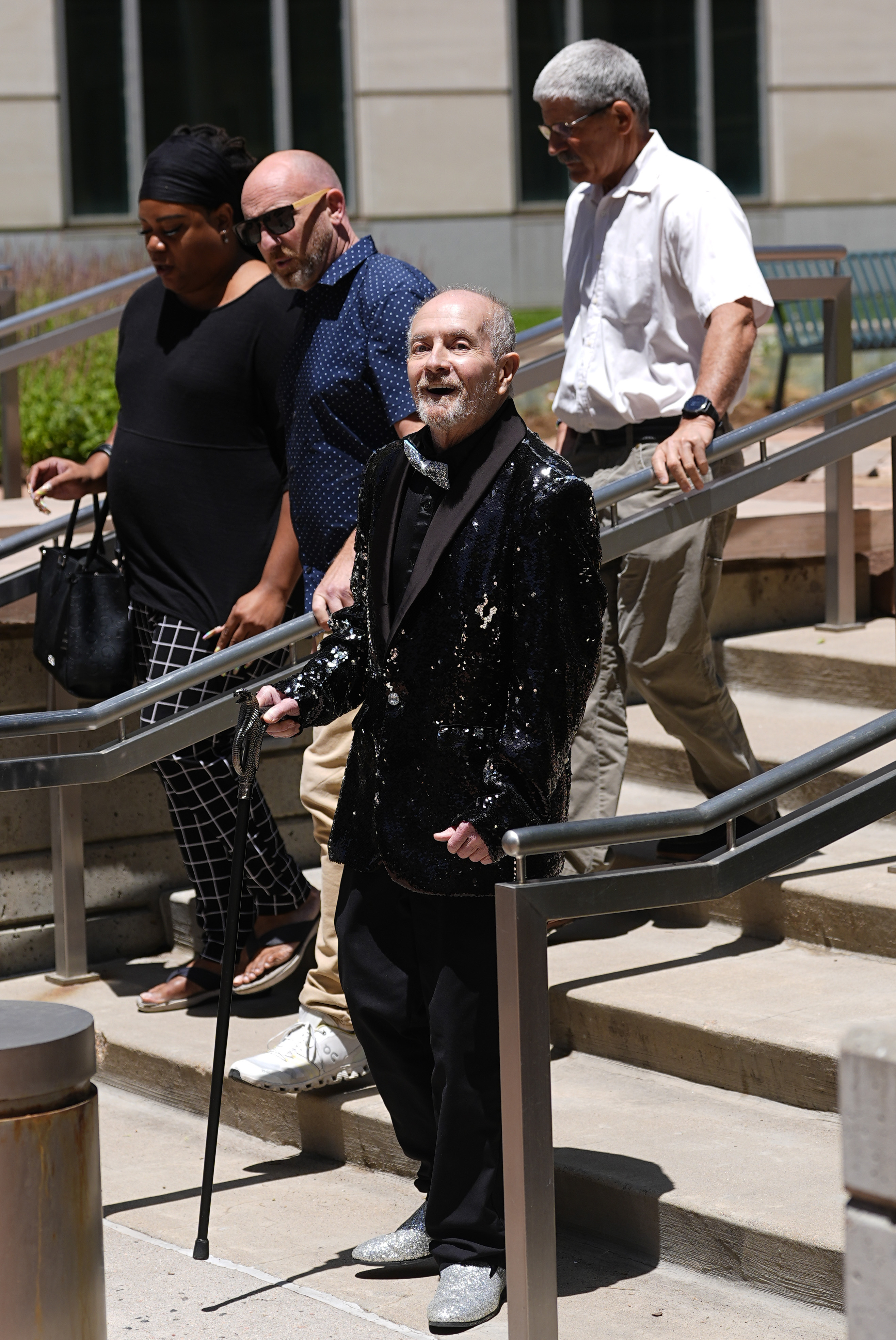 Ed Sanders (front) heads over to speak to reporters after the sentencing of Lee Alrich, the man who shot him in the foot.<br />(David Zalubowski / AP Photo)