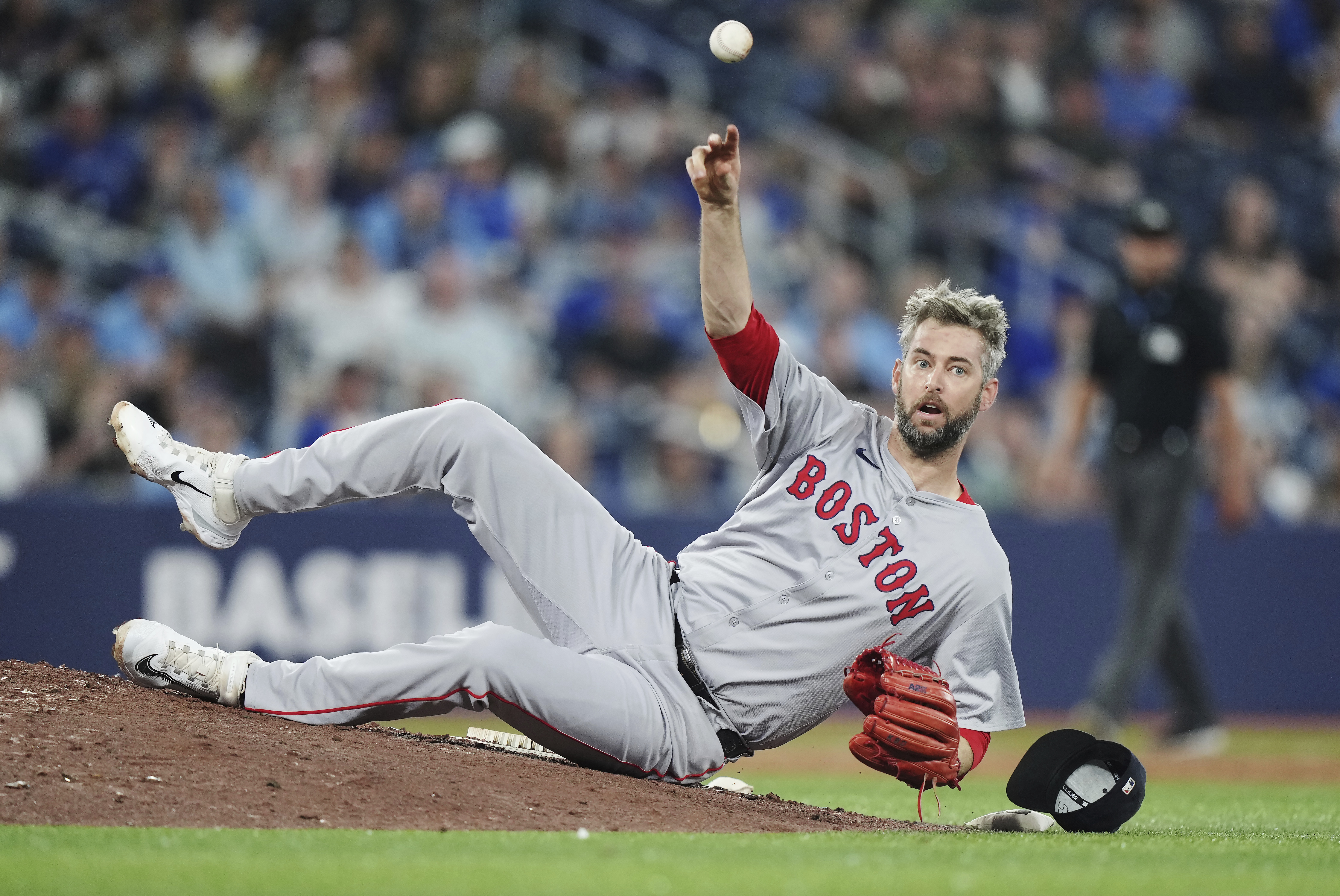 Boston Red Sox pitcher Chris Martin throws to first base as he trips on the mound fielding a ground ball against the Toronto Blue Jays during the ninth inning of a baseball game in Toronto on Wednesday, June 19, 2024.<br />(Nathan Denette / The Canadian Press via AP)