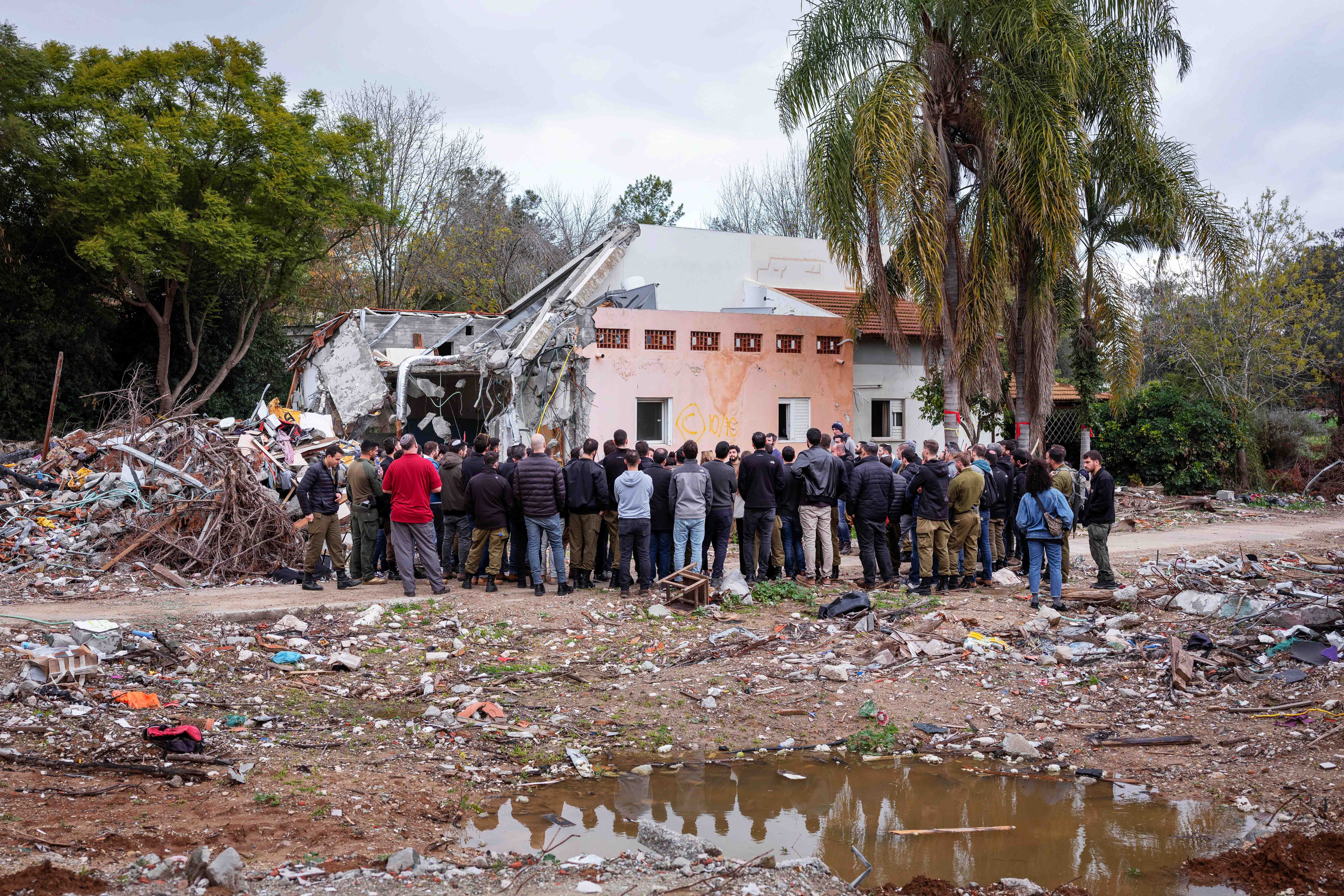 A group of Israelis visit a damaged house following the Oct. 7 Hamas militants attack on Israel in Kibbutz Beeri, southern Israel, on Friday, Jan. 28, 2024. A new kind of tourism has emerged in Israel in the months since Hamas’ Oct. 7 attack. For celebrities, politicians, influencers and others, no trip is complete without a somber visit to the devastated south that absorbed the brunt of the assault near the border with Gaza.<br />(Oded Balilty / AP Photo)