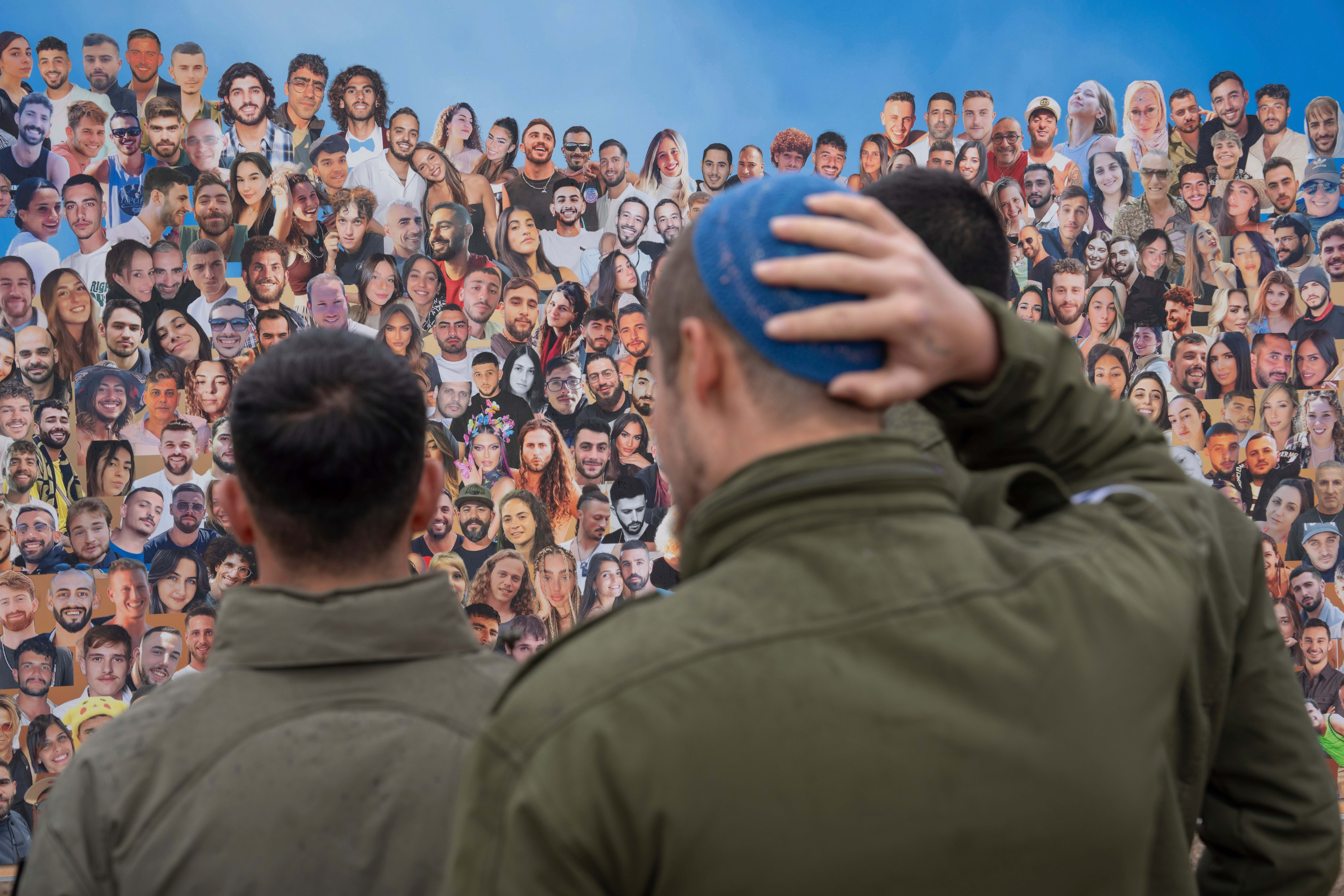 Israeli soldiers look at pictures of revelers killed on Oct. 7, 2023 at the Nova music festival by Hamas militants during a cross-border attack, as they visit the site in Re&#039;im, southern Israel near the Gaza border, Thursday, Jan. 28, 2024.<br />(Oded Balilty / AP Photo)