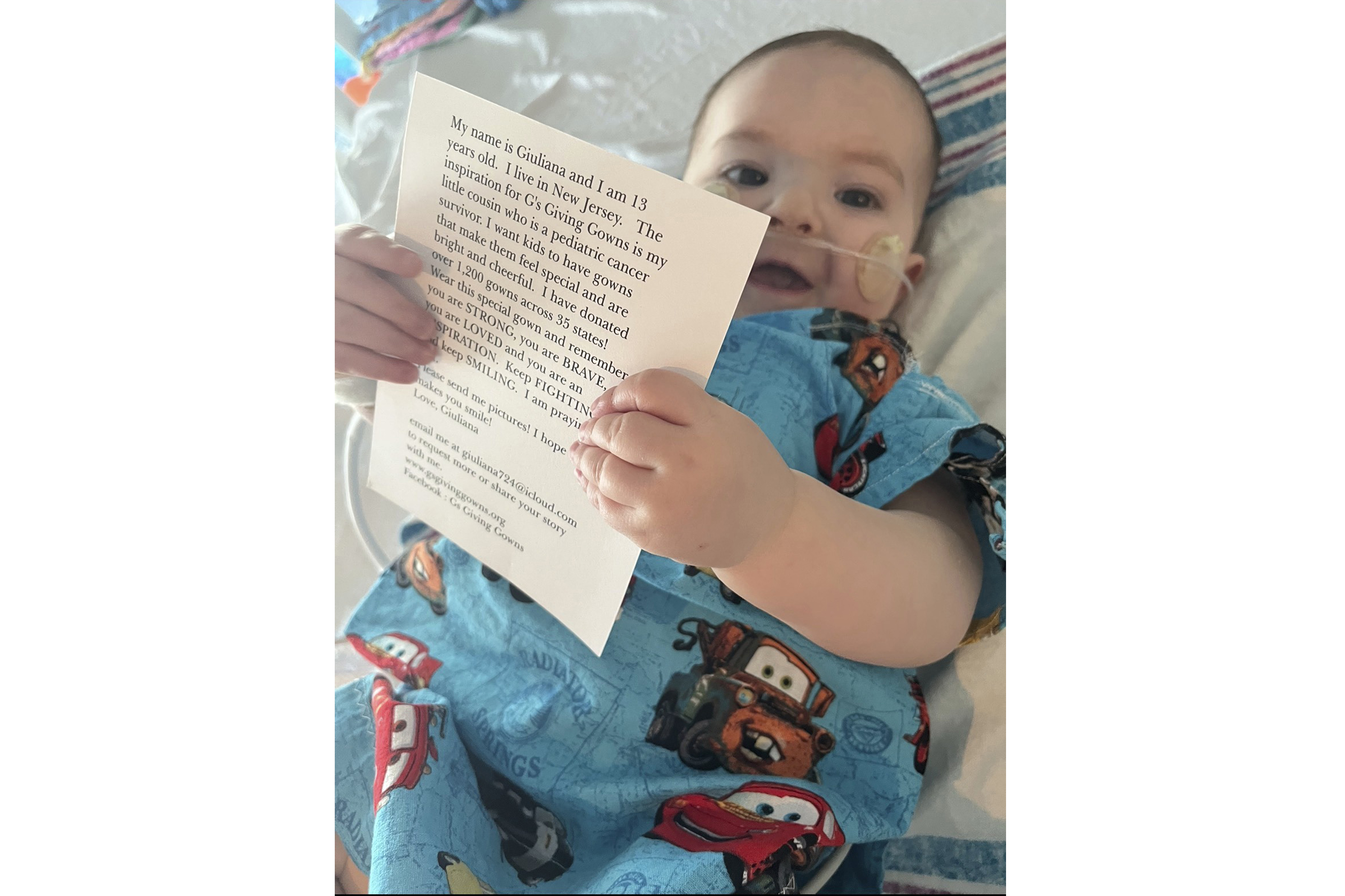 1-year-old Vito DiSimone holds a card that came with the special hospital gown he was given during a stay at NYU Langone Medical Center in New York on Jan. 11, 2024.<br />(Samantha DiSimone / AP Photo)