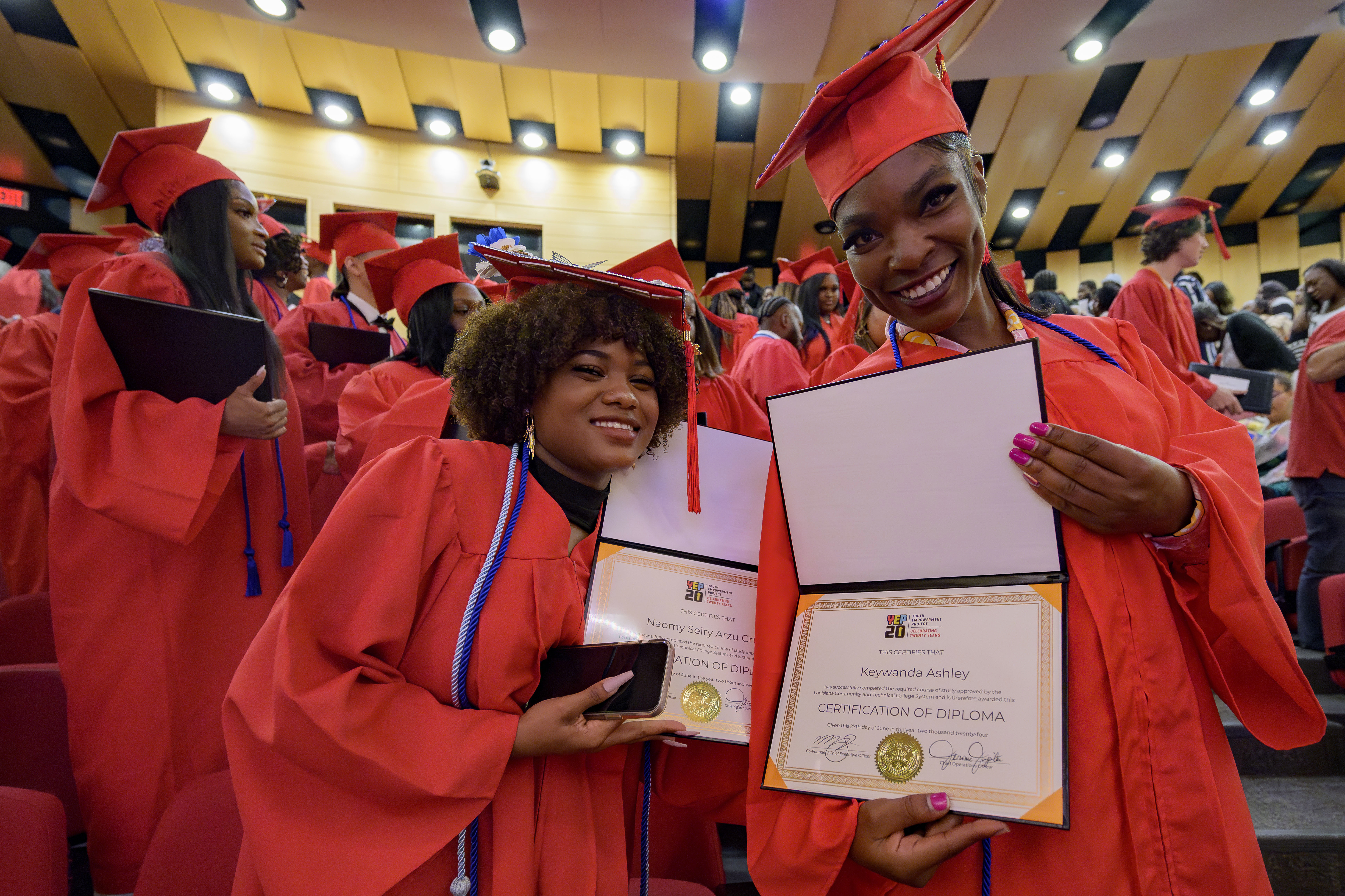 Keywanda Ashley (right) and Naomy Seiry Arzu Cruz show off their high school equivalency (HiSET) diplomas during a graduation ceremony for the Youth Empowerment Project (YEP), a New Orleans-based non-profit organization which received money from the NBA Foundation program in New Orleans, Thursday, June 27, 2024.<br />(Matthew Hinton / AP Photo)