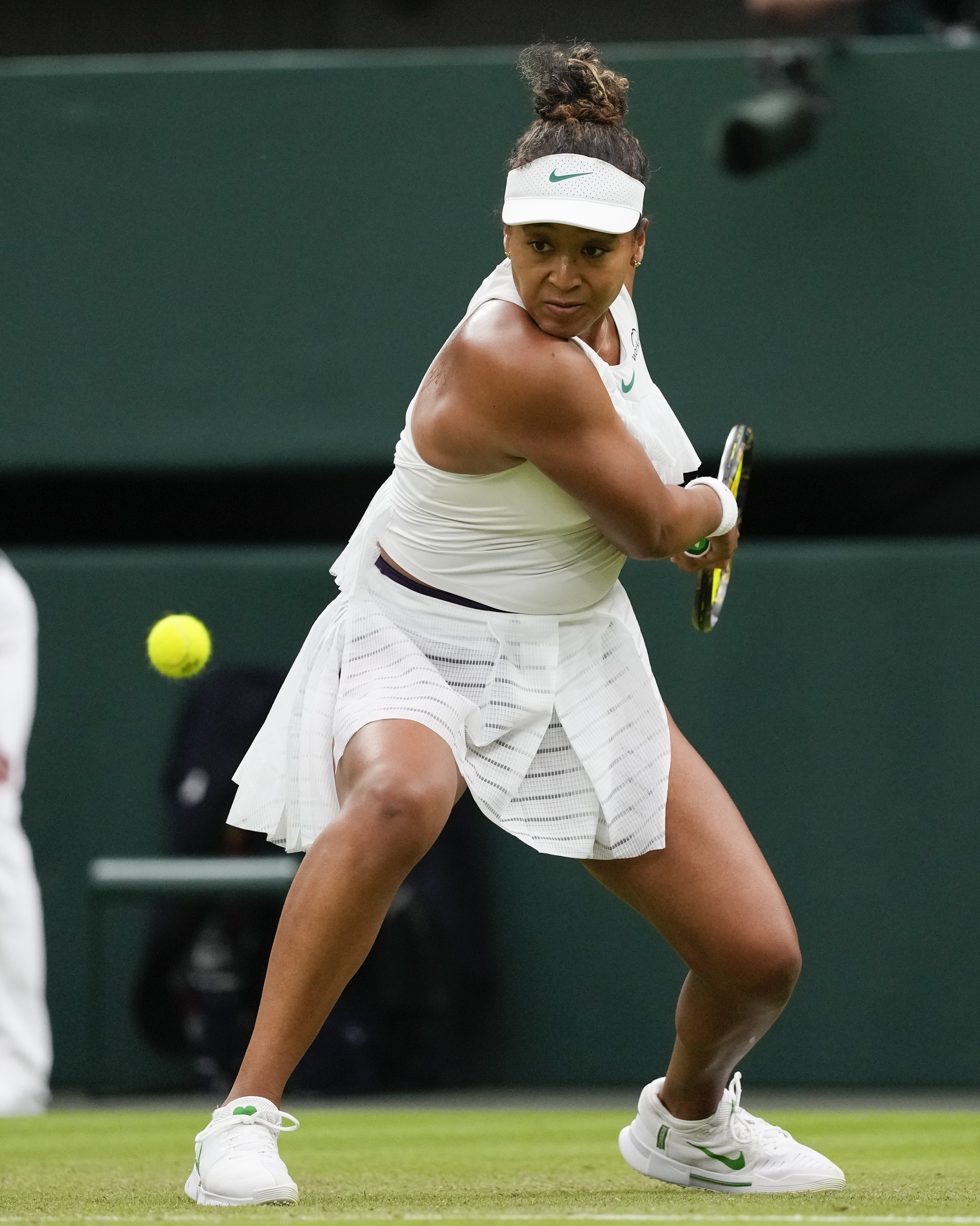 Naomi Osaka of Japan plays a backhand return to Emma Navarro of the United States during their match on day three at the Wimbledon tennis championships in London, Wednesday, July 3, 2024.<br />(Alberto Pezzali / AP Photo