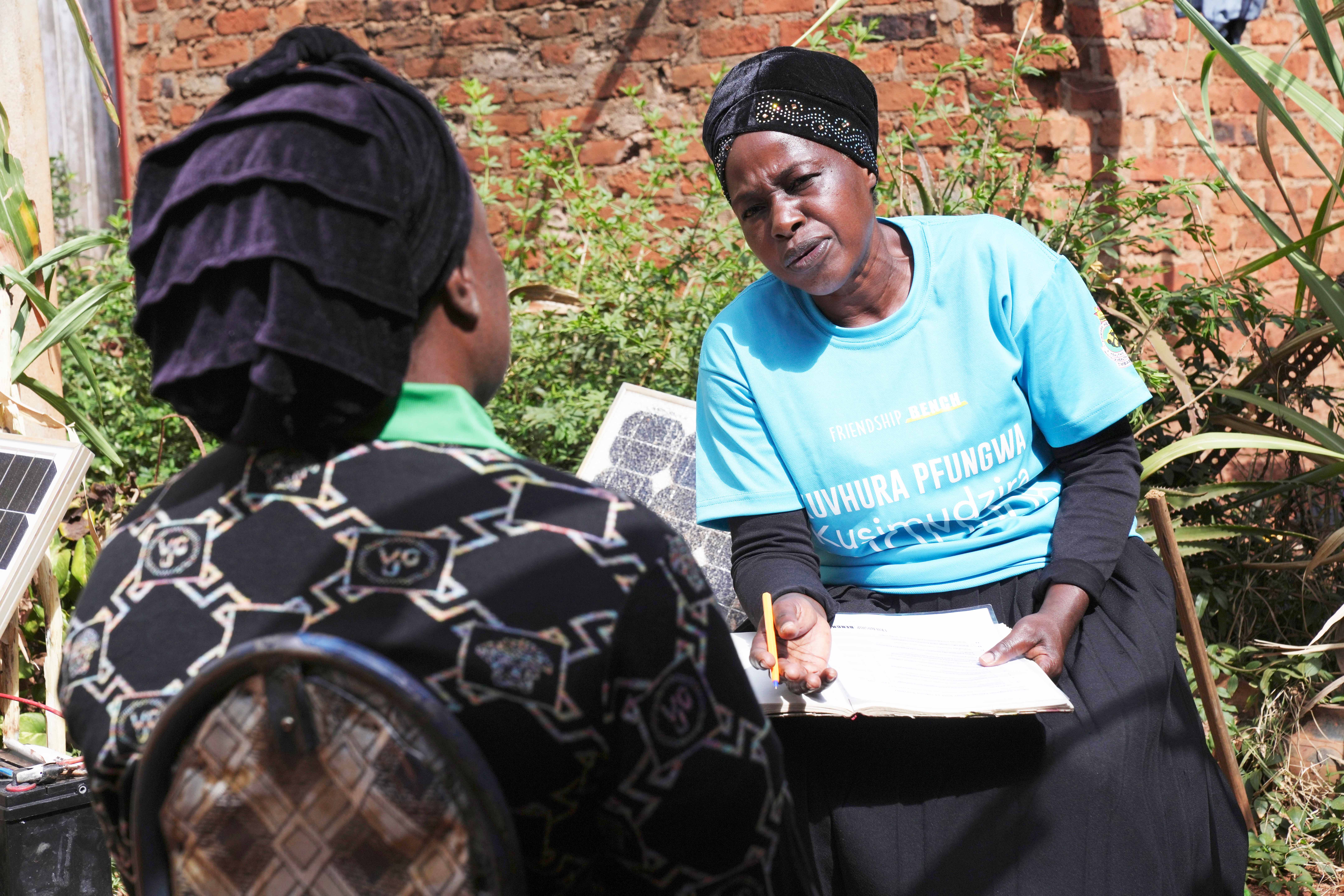 Siridzayi Dzukwa, a grandmother (right) talks to Tambudzai Tembo outside her house in Hatfcliffe on the outskirts of the capital Harare, Zimbabwe, Wednesday, May 15, 2024.<br /> (Tsvangirayi Mukwazhi / AP Photo)