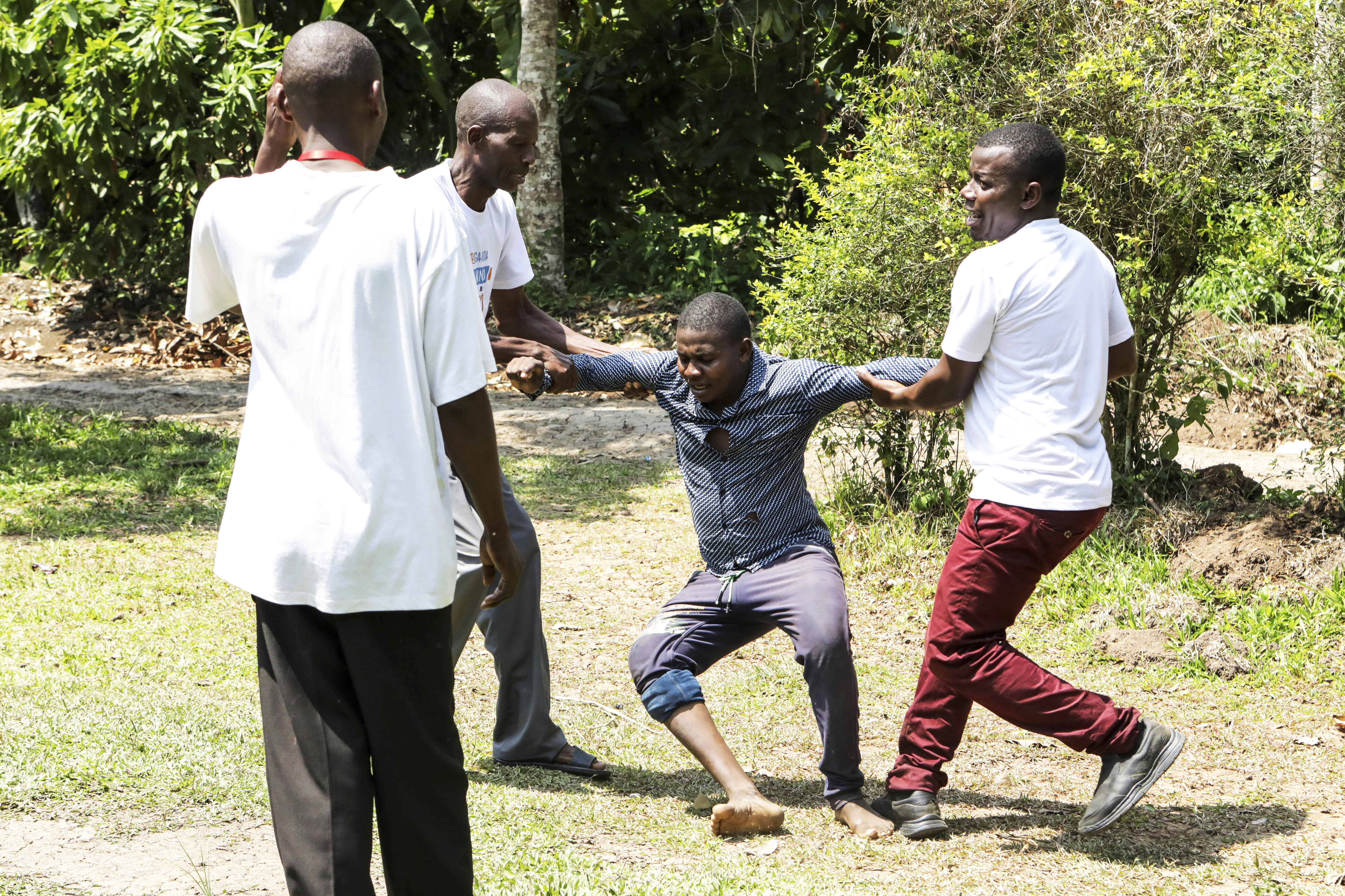 Mankind Club members alongside Godfrey Tumwesigye, centre, during a gender violence drama skit at Bundibugyo district, Western Uganda, Saturday, June 29, 2024.<br />(Hajarah Nalwadda / AP Photo)